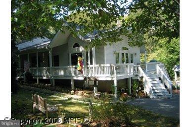 Beautiful open floor plan split level in downtown Hollywood! 3 car detached garage, with lots of paved parking. Full finished walk out basement with fireplace with a woodstove insert. Main level has a pellet stove, separate dining and family room. Deck, fenced yard and all on over 2 acres.   Shows like a model.