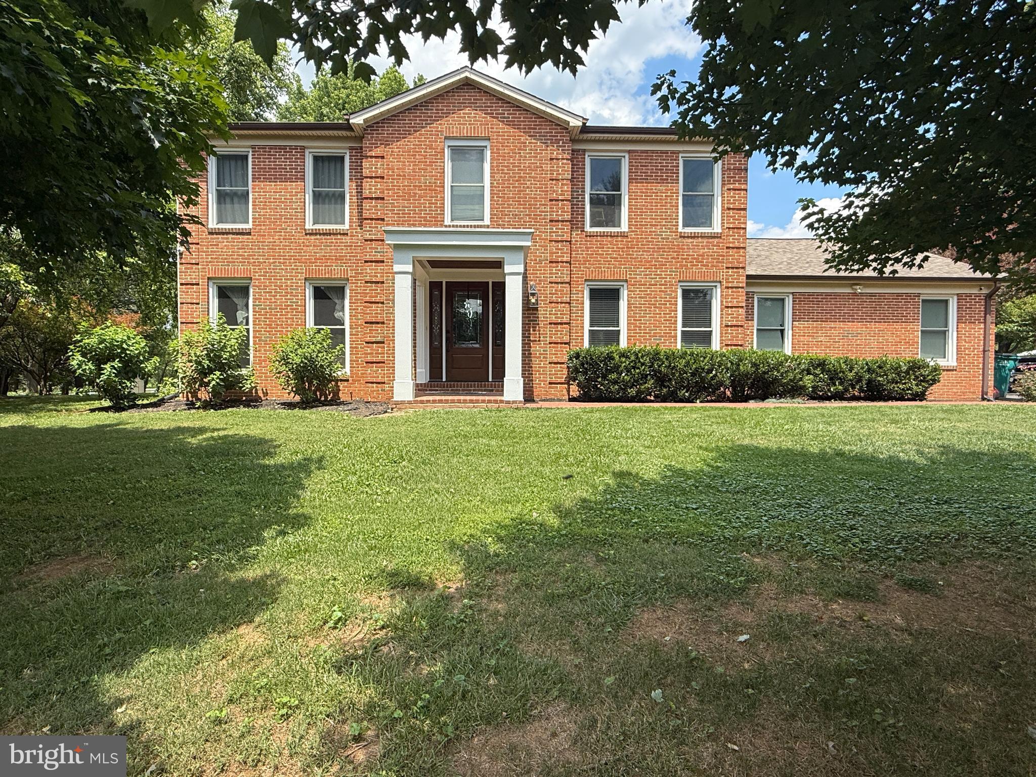 Welcome to this beautifully updated brick-front colonial nestled in the highly sought-after Muncaster Manor community of Derwood. Blending timeless curb appeal with modern updates, this exceptional home offers spacious living areas, thoughtful design and an incredible outdoor setting perfect for everyday living and entertaining. The heart of the home is the stunning, open-concept kitchen featuring warm wood-tone cabinetry, elegant white quartz countertops, abundant prep space and seamless flow into the inviting family room highlighted by a cozy fireplace. Wide-plank wood-look tile flooring extends throughout the main level, creating a cohesive and sophisticated aesthetic. A spacious den provides the perfect home office or flex space, while the formal living and dining rooms offer additional areas for gathering and hosting. An oversized laundry and mudroom conveniently connects to the attached two-car garage. Upstairs, the expansive primary suite serves as a private retreat with a generous walk-in closet and dressing area, along with a beautifully renovated en-suite bathroom. Three additional spacious bedrooms share an updated hall bathroom, providing comfort and flexibility for family, guests or additional workspace. The finished lower level expands the home's living space with a large recreation and entertaining area, a full bedroom and full bathroom, plus an abundance of storage. Step outside to enjoy the meticulously landscaped backyard designed for entertaining and relaxation. Flagstone hardscaping creates multiple outdoor living spaces, including a spacious patio for dining, a dedicated fire pit gathering area and an expansive, level lawn offering endless opportunities for recreation, gardening, or outdoor enjoyment. Ideally located just minutes from the ICC (MD-200), I-270, shopping, dining, parks, and numerous commuter routes, this exceptional home offers the perfect combination of comfort, style, convenience, and location.