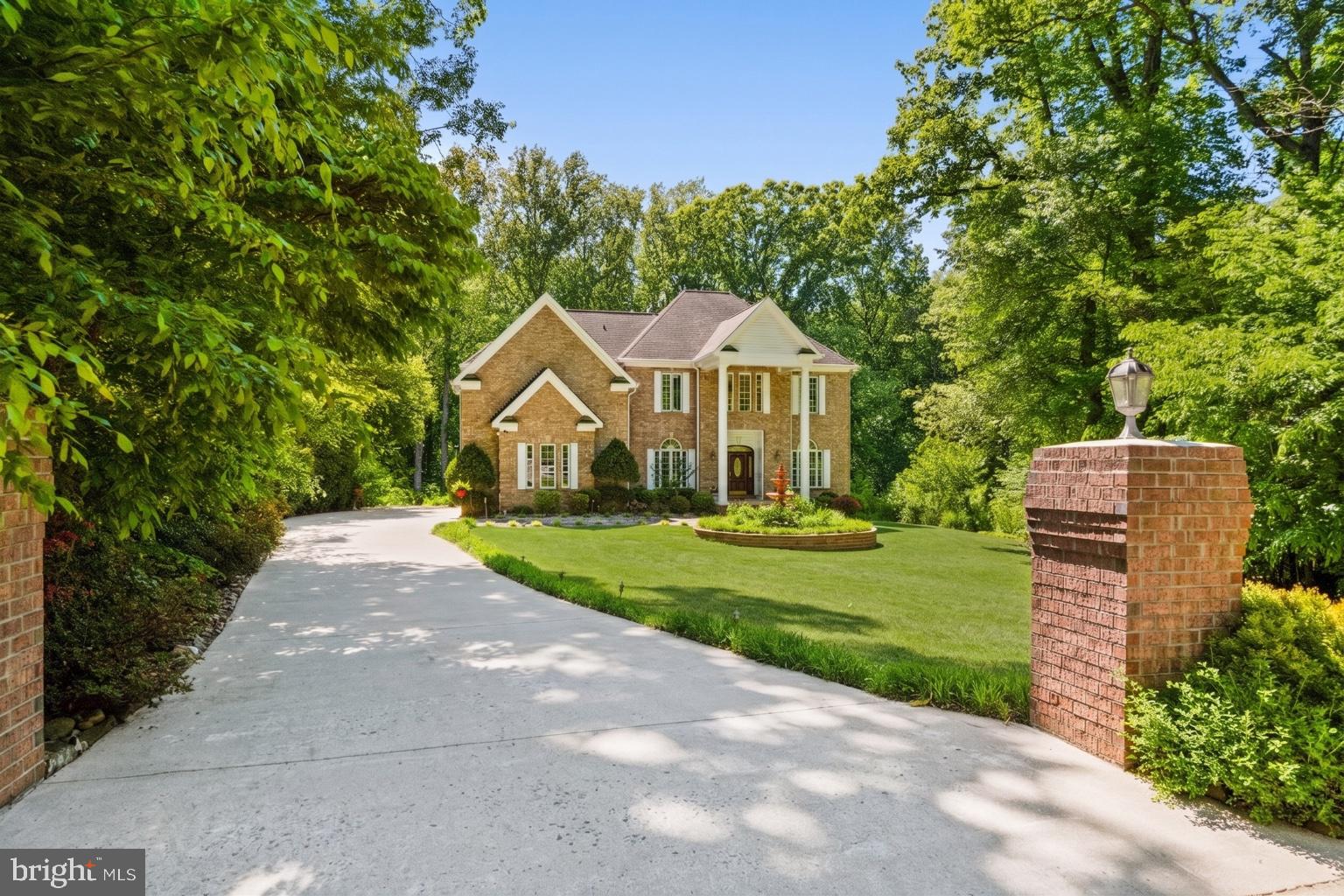 Offer deadline is 8pm on May 18. Welcome to 3750 Prosperity Ave — a stately all-brick custom estate privately situated on a serene 0.58-acre lot backing to mature woods in one of the area’s most desirable locations. Originally designed and built by an architect as a personal residence, this timeless Colonial-inspired home showcases elegant architecture, quality craftsmanship, and nearly 6000 SQFT finished living space across three levels. From the moment you arrive, the home makes a lasting impression with its classic brick façade, grand front columns, professionally landscaped grounds, expansive front lawn, and elegant fountain creating true estate-style curb appeal. Inside, the home offers 5 bedrooms, 4 full bathrooms, and 2 half baths, thoughtfully designed with soaring ceilings, oversized windows, and abundant natural light throughout. The elegant main level features a formal living room, spacious formal dining room, main level office  connected by a beautiful see-through fireplace that adds warmth and architectural character to the space. The breathtaking family room showcases approximately 20-foot ceilings and a dramatic wall of windows overlooking peaceful wooded views, filling the home with incredible natural light and creating a truly grand yet inviting atmosphere. The gourmet kitchen is exceptionally spacious and designed for both everyday living and entertaining, featuring rich cherry cabinetry, granite countertops, stainless steel appliances, a built-in KitchenAid refrigerator, professional-grade 48” FiveStar gas range and custom vent hood. Just off the kitchen is a charming breakfast area with vaulted ceilings and large windows overlooking the private backyard, creating the perfect casual dining space filled with natural light. Upstairs, the luxurious south-facing primary suite features hardwood flooring, a spa-inspired bath with whirlpool tub, and spacious His and Her walk-in closets. Three additional upper-level bedrooms include a Jack-and-Jill bath and a separate ensuite bedroom offering comfort and flexibility for family and guests. The fully finished walkout lower level offers exceptional entertaining space with a large recreation room, wet bar, half bath, and a versatile bonus room with its own full bath,  ideal for a home office or optional bedroom space for guests. Outdoor living is equally impressive with over 600 sqft  composite decking, stone patios, mature landscaping, and tranquil wooded surroundings that provide exceptional privacy and a peaceful natural setting. Major updates include: main-level furnace (2022), main-level A/C (2024), water heater (2019), concrete driveway (2011), and front, side, and rear patios (2015). Perfectly located just minutes from the Mosaic District, INOVA Fairfax Hospital, Dunn Loring Metro, parks, and downtown Fairfax, with easy access to I-495, Route 50, and Route 236 for convenient commuting. Zoned for highly sought-after Mantua Elementary, Frost Middle, and Woodson High School. A rare opportunity to own a truly custom home that perfectly blends timeless architecture, luxury finishes, generous living space, privacy, and an unbeatable location. Some photos have been virtually staged for illustrative purpose