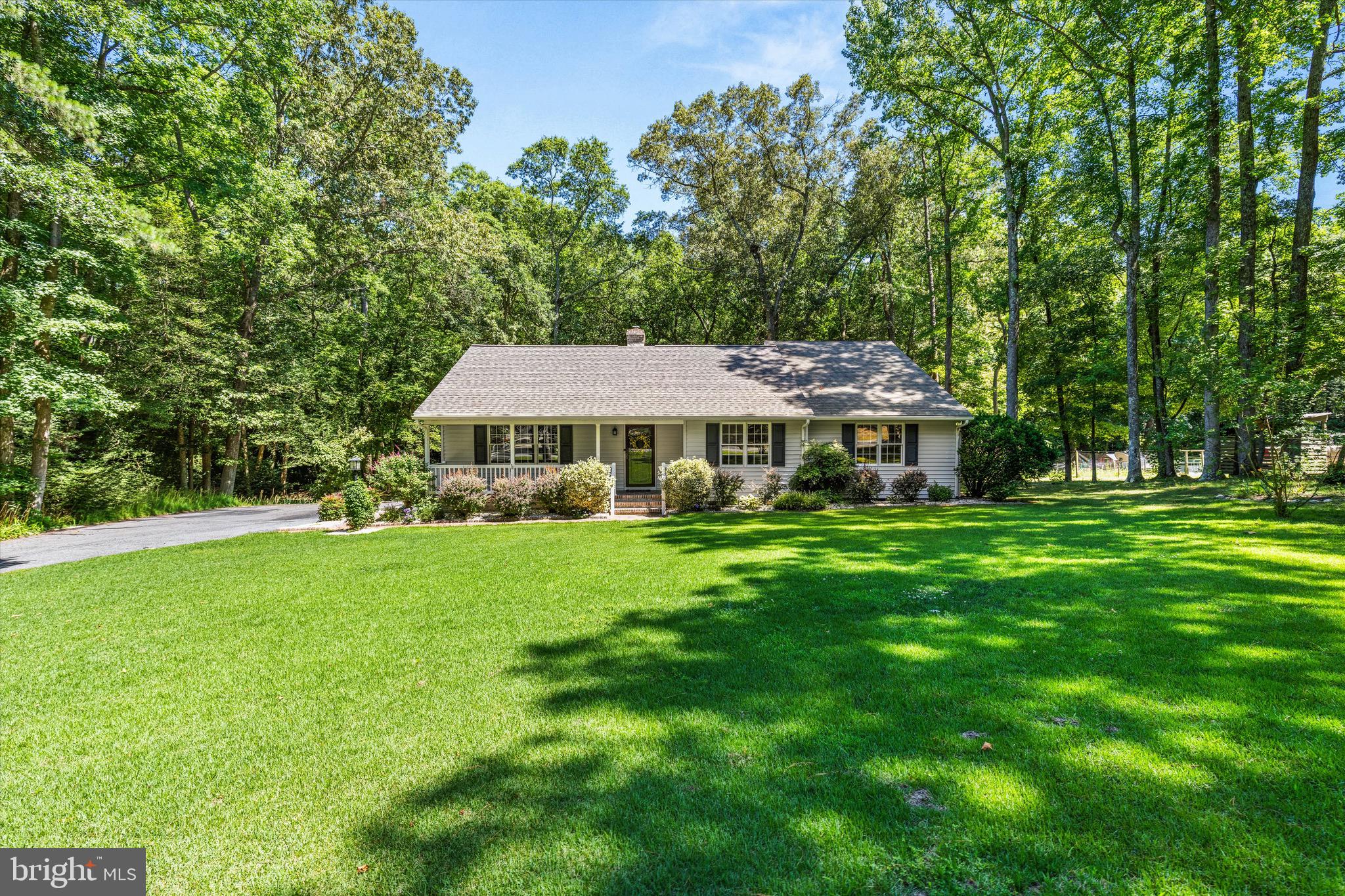 Welcome home to this beautifully maintained rancher offering the perfect blend of warmth, character, and updates. Picturesque landscaping, a welcoming flagstone front porch with vinyl railings, and a spacious paved driveway create exceptional curb appeal from the moment you arrive at this 1.42 acre home. 

Step through the front door into a generous foyer that leads to the inviting living room, featuring a stunning cathedral wood ceiling, luxury vinyl plank flooring, and a cozy brick gas fireplace that creates the perfect gathering space.

The kitchen offers a tile backsplash, built-in bench seating for casual dining, and a gas stove, making it both functional and inviting. Just beyond, glass French doors lead to a charming sunroom showcasing flagstone flooring and distinctive arched wood windows that bring the outdoors in.

This home features three bedrooms and two thoughtfully renovated bathrooms, updated with custom tiled showers featuring multiple built-in niches for added convenience. The primary bath offers a spacious walk-in shower, while the second bath includes a beautifully tiled tub/shower combination. The primary suite overlooks the private wooded backyard, creating a peaceful retreat.

Outdoor living is just as impressive with a low-maintenance composite rear deck overlooking the private, wooded backyard. A spacious two-section storage shed provides plenty of room for tools, hobbies, or outdoor equipment. The oversized paved driveway offers ample parking for guests, recreational vehicles, or multiple cars.

From its custom finishes to its inviting indoor and outdoor living spaces, this move-in-ready home offers comfort, style, and plenty of space to enjoy.
