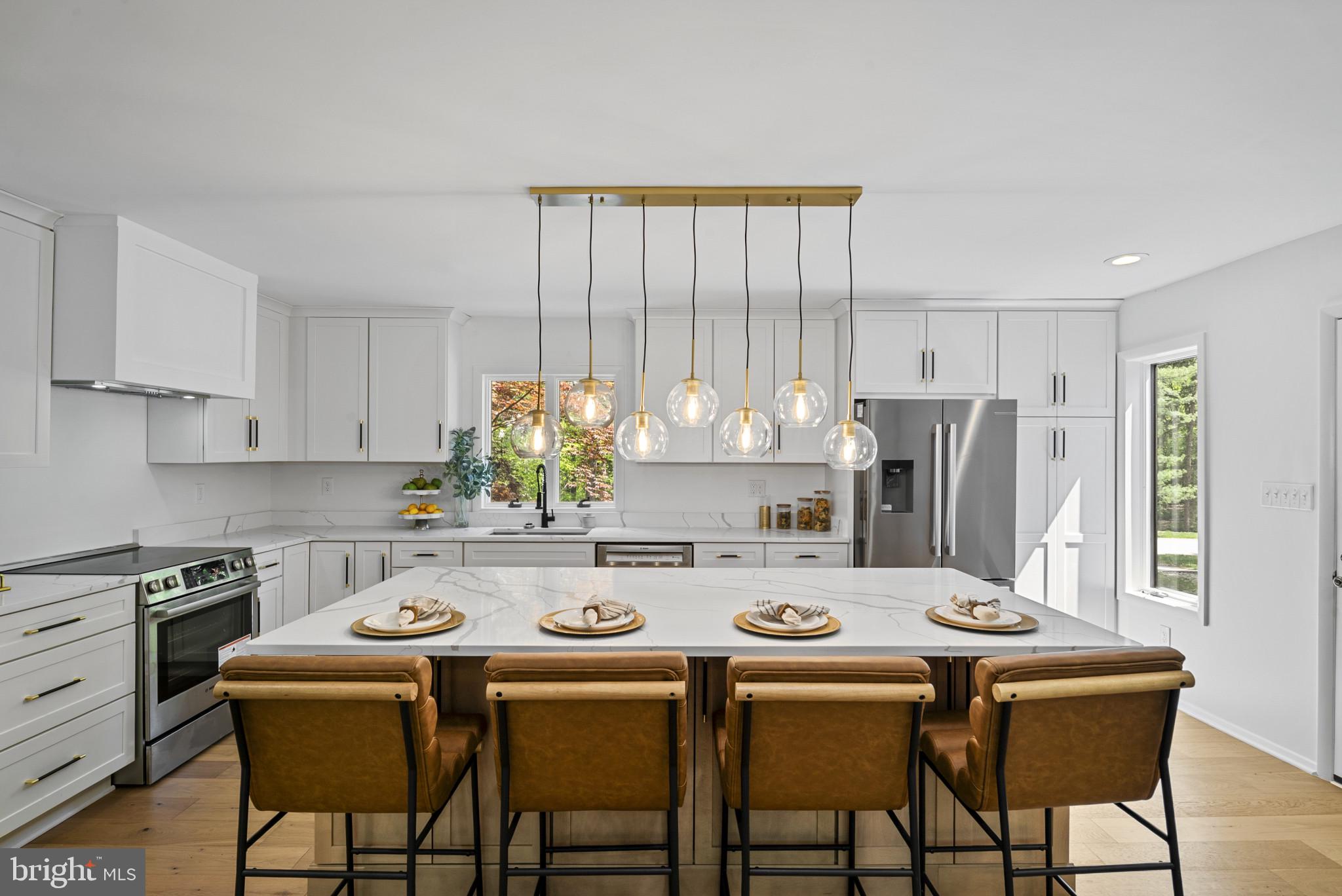 A masterfully reimagined residence offering refined modern living, this home has been thoughtfully renovated from top to bottom with elevated finishes and cohesive design throughout.  At the heart of the home is a stunning, fully remodeled kitchen featuring brand-new appliances, custom cabinetry with designer hardware, and sleek countertops—perfectly blending style and functionality.  White oak hardwood flooring runs throughout, complemented by all-new lighting and plumbing fixtures that enhance the home’s clean, contemporary aesthetic.  The home offers four bedrooms, including three on the upper level with a reconfigured, luxurious primary suite. A main-level en suite bedroom adds exceptional flexibility for guests or multi-generational living. All bathrooms have been completely renovated with sophisticated, spa-like finishes.  A newly added basement expands the living space and includes a dedicated laundry room, adding both comfort and convenience as well as ample storage space.  The exterior has been freshly painted with new front landscaping, enhancing curb appeal and creating a polished first impression.  A true turnkey offering, this residence delivers modern elegance, thoughtful design, and effortless livability throughout.