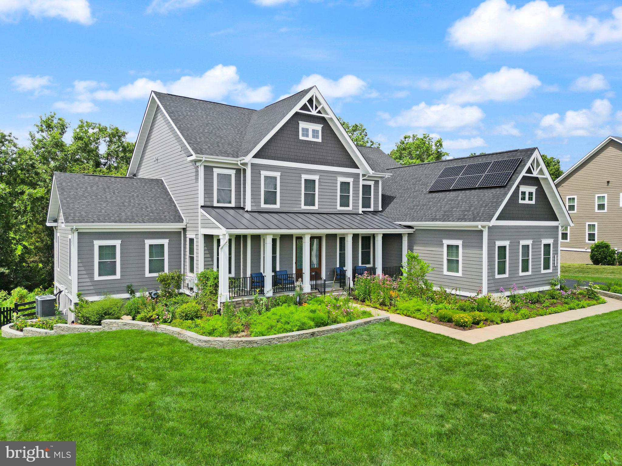 Welcome to luxury living in Willowsford at its absolute finest.  Built in 2020, this spectacular east-facing Regents Park II model is equipped with so many high-end upgrades - cosmetic, structural, and technological - and truly offers every characteristic and amenity you are looking for in one of Loudoun County's finest neighborhoods.  As you approach the property driving down a quiet, private street, you'll start to feel right at home in this incredibly beautiful part of The Greens. The home's powerful curb appeal stands out as it boasts an eye-catching exterior accompanied by a vibrant, healthy garden that is an accredited Audubon At Home Wildlife Sanctuary! Entering through large wooden doors with dual electrochromatic windows, you'll step into the home's impressive foyer and immediately begin to notice the details that separate this home from the rest -   beautiful crown moulding, extensive trim work, and carefully selected architectural details. The expansive main level boasts an incredible open layout and begins with a lovely dining space with a tray ceiling, wainscoting, and plenty of natural light. Now step into your stunning, magazine-worthy two-story great room adorned with coffered ceilings, a magnificent fireplace upgraded with stone, built-in shelves, and massive windows that welcome in so much natural light. This living space flows seamlessly into a stunning gourmet eat-in kitchen with upgraded cabinets, dual oversized islands, beautiful white quartz countertops, a farmhouse sink, two dishwashers, extra mini-fridge, and walk-in pantry!  The refrigerator is also equipped with a water purification system/reverse osmosis system, and a line can be connected right to your coffee maker too!  This level is also home to two full home-office spaces, both with lovely French doors and plenty of space. Or convert these to sitting rooms, or recreation spaces - so many options!  If that was not enough, there is also a FULL GUEST SUITE on the main level. It comes complete with a large, well- lit bedroom, walk-in closet, and full bathroom with a double-vanity and upgraded shower. Perfect for the parents, in-laws, guests, or anyone else!  Heading up either way on the grand double-sided staircase, you'll find an upper level with 4 bedrooms, each of which is equipped with its own full bathroom.  The primary suite is an absolute dream as it boasts a gorgeous hand-painted Roman clay tray ceiling, sit-in space where you can enjoy the lovely fireplace, massive dual walk-in closets, and a one-of-a-kind primary bathroom. Designed with Alicia Thomasson Interiors, this bathroom is highlighted by a stunning chandelier against additional Roman clay, an oversized soaking tub, dual vanities with exquisite hardware, mirror, and light fixture choices, and a spacious shower with beautiful tile.  The upper level also offers a fully equipped laundry room as well that is complete with fantastic cabinet space!  Downstairs you'll enjoy an incredible walk-out basement that boasts so much open space and room for activities.  The full bar offers a great space to relax as you decompress, play some ping pong or pool, or even head into the two-level movie theater to catch some entertainment.  The basement also offers a 6th legal bedroom, and a significant amount of unfinished storage space.  Now, the outdoor space is what dreams are made of!  Custom designed and built by Rock Water Farm, the back is home to a spacious and high-end Trex deck, a gorgeous covered flagstone patio complete with a stone fireplace, natural boulder work, and was designed with a gunite pool in mind - just ask for rendering!  All of this backs to a fully protected and untouched conservation area in Aldie, offering complete privacy!  Additionally, the home comes equipped with paid-off high-performing solar panels that convey with a warranty, 16 zone irrigation system, outdoor lighting, speaker systems, and more.  This home is a real dream come true in Willowsford - come see it today!