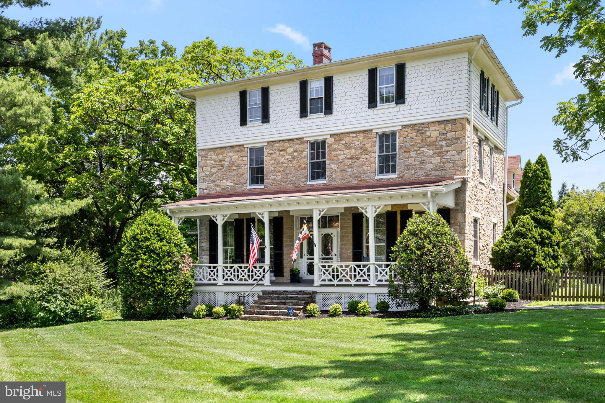Welcome to Graystone in Historic Lutherville, where timeless elegance meets modern living! This gracious stone home built in 1857 at the corner of Kurtz Avenue and Church Road on almost three quarters of an acre manicured property blends old world charm with modern amenities and updates. This exceptional home offers contemporary comforts and conveniences in a beautifully preserved residence. From the front porch to the back gazebo, there is so much to enjoy. Step inside a spacious front center hall and foyer to soaring ceilings and loads of natural light, with original architectural details and delights. Six bedrooms and three full and one half baths offer everyone their own spaces and flexibility for home offices and gaming rooms. A second level full laundry room and walk-in closet offer today's amenities combined with the quality of construction of another era. Graystone's kitchen was remodeled and updated to seamlessly blend functionality and convenience in keeping with the historic nature of the home. Enjoy banquette seating, a walk-in pantry, and another pantry near the Wolf gas range. Perfect for entertaining. The mud room leads to a den offering a bar with beverage refrigerator, all located just outside the family room. The second level offers a home office with built-in shelving in the space above the main level foyer and two primary suite options, each with it's own remodeled bathroom. The back stairs lead to the laundry room and a walk-in closet off one of the suites. The third floor features four large bedrooms and a full bath, plus large foyer or hallway area. Large portions of the level yard are fenced, giving a perfect area for lacrosse or soccer goals. And the three-car-garage offers storage and car space.  This home is a contributing home to  Historic Lutherville.