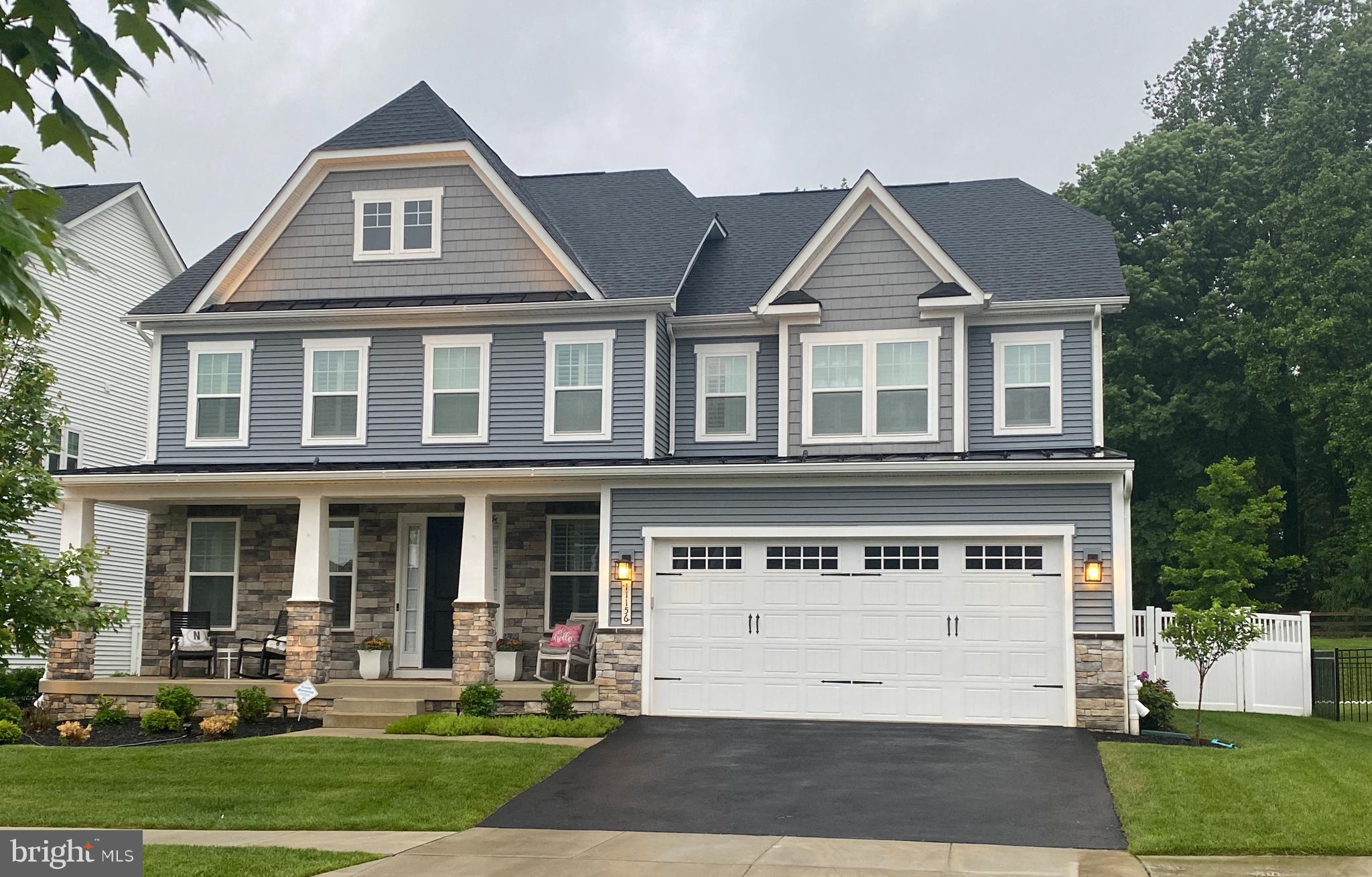 Popular Longwood model in Maple Lawn South with all the bells and whistles!  This outstanding property has four bedrooms, four full and one half bathrooms, a den/office on the main level and a finished walk-out lower level with an option in place for a fifth bedroom/guest room.  The chef's kitchen, complete with walk-in pantry, double wall ovens, five-burner cooktop, wine fridge and a huge island with breakfast bar is open to the great room and leads out to a fabulous screened porch with a stacked stone gas fireplace.  Upstairs, off the large open hallway, are double doors leading into the primary suite, with two walk-in-closets and bathroom with extended double vanity, soaking tub and separate shower.  There are three additional bedrooms, one with its own full bathroom and a Jack and Jill bathroom between the other two bedrooms.  The back yard is an entertainer's dream with a custom outdoor kitchen, brick pizza oven, deck, patio and extensive hardscape.  The landscaping around the entire property is pristine.  Did I mention there is a central vacuum system and an EV charger in the garage?  Solar panels will be paid in full at settlement (no charge to buyer).  Maple Lawn is well loved for its community amenities, shopping, schools and restaurants.