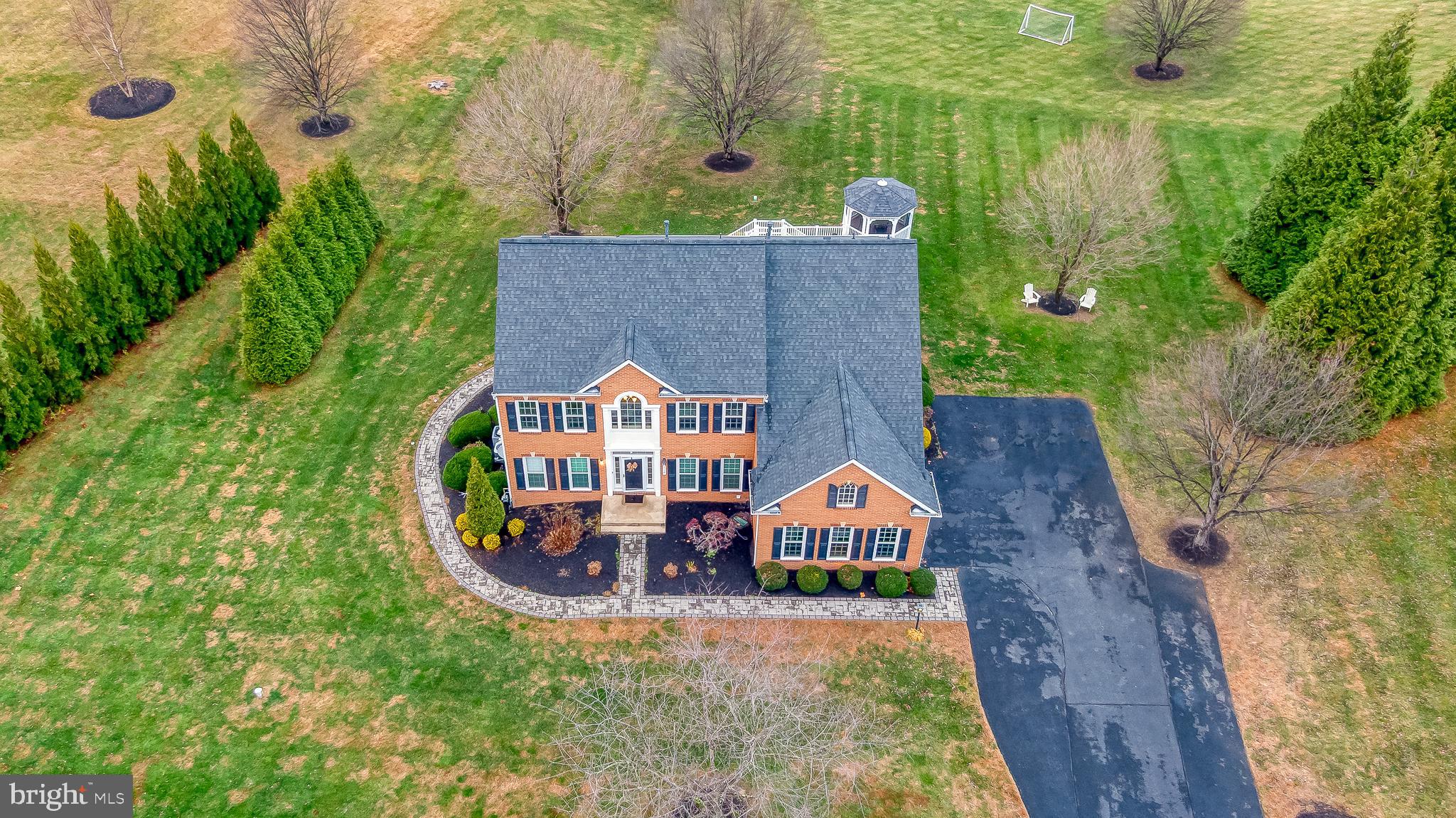 Welcome to 112 Bower Lane in the desirable Colvard Manor community of Forest Hill. Step inside the two-story foyer to find wide-plank hardwood floors throughout and fresh neutral paint. The main level offers a private office with built-ins and French doors, formal living and dining rooms with elegant molding, and a dramatic two-story family room. The family room includes a gas fireplace, surround sound, and a ceiling fan, and it opens to the renovated eat-in kitchen. The kitchen features stainless steel appliances, a hood vent, tile backsplash, gorgeous countertops, a center island with a breakfast bar, and a walk-in pantry. The kitchen flows seamlessly into a bright sunroom with a vaulted ceiling. A convenient mudroom/drop zone and laundry area sit just inside the side-load garage. Step outside to the maintenance-free deck with gazebo and stairs leading to a stunning paver patio with fire pit. This area includes a private walkway and separate guest entrance - perfect for entertaining. Upstairs you'll find hardwood floors throughout, generously sized bedrooms, and a spacious primary suite featuring a tray ceiling, a walk-in closet, and a beautifully renovated primary bath with a soaking tub and separate shower. The finished lower level offers incredible additional living space with a handmade bar, a recreation room featuring a barn door, a pellet stove, a powder room, an extra washer and dryer, a kitchenette, a water filtration system, and a bedroom with an attached full bath - ideal for guests or an in-law suite.