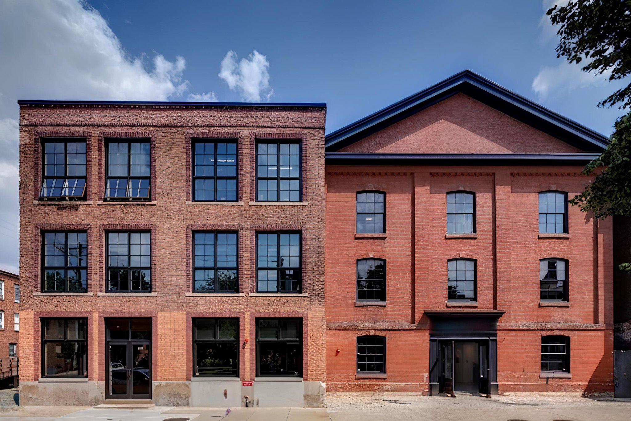 Welcome to Philadelphia's most extraordinary boutique corporate headquarters and creative space.  1227 North 4th Street is a stunning adaptive reuse of two historic buildings seamlessly merged into one turn-key creative office building spanning 28,514 SF over three floors.   Originally constructed in 1854 as St Luke's Lutheran Church and subsequently used as a box factory, the building was meticulously converted into a modern office building in 2013.  An abundance of original architectural details remain, including its historic facade and A-frame roof, exposed timber columns and beams, hardwood floors, and exposed brick walls.  The renovation included the installation of all new mechanical systems and exposed ductwork, windows, restrooms, lighting, elevator, and fiber-optic wiring throughout. A 50KW solar roof array was installed in 2021, greatly reducing occupancy costs.   Owner-occupied for the last decade, the layout includes a mix of glass conference rooms and private offices, open seating areas, a large kitchen and roof deck.  The property offers eight-car parking on the attached corner surface lot and rear driveway.  Two separately deeded residential lots on Thompson Street are included in the sale.  Enjoy an unparalleled work environment just one block north of Girard Avenue and a few blocks from exciting destination retail and Food & Beverage options in Fishtown!