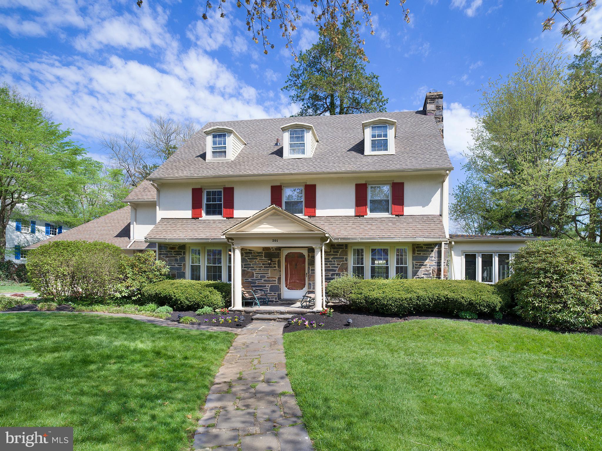 Welcome to this newly renovated, beautiful, 5/6 bedroom Center Hall colonial, located on one of the prettiest blocks Merion, that is a move-in-ready WOW! A massive six month renovation in 2022, updating every inch of space, means you don’t have to. The project was entrusted to an award-winning interior designer, who took this generously proportioned, light flooded house to the next level. The finishes and custom millwork reflect modern design trends, while thoughtful design ensures convenient family living. Picture the graciousness, workmanship and elegance of a 100 year old home with all of today’s luxuries. Highlights include a fabulous chef’s kitchen, new flooring, lighting, carpeting, painting and window treatments, a converted gas fireplace connecting living and family rooms, and a primary suite with private dressing room and two brand new his-and-her bathrooms. 
Step into the inviting foyer and discover a home where every room boasts windows with two exposures, ensuring light throughout the day. To the right is lovely, airy living room whose centerpiece is a beautiful vintage fireplace mantle, newly converted to gas, with glass French doors leading to the family room with custom cabinetry. To the left of the foyer is an attractive dining room that can comfortably seat 14 guests. Flowing from the dining room is the gourmet kitchen, showcasing light custom cabinetry, granite countertops, subway tiled backsplash, stainless steel Thermador appliances, 2 ovens, a warming drawer, 2 sinks, 2 Asko dishwashers, and a banquette breakfast area. The highlight is one wall of original stone, a stunning backdrop to the rest of the kitchen. Conveniently located off the kitchen is a 2-car attached garage, a door leading to the yard, a back door leading to a BBQ, and a rear staircase that leads to the second floor. A powder room serves the first floor. 
The main staircase leads to the second floor, where you'll discover two large bedrooms sharing a renovated Jack and Jill bathroom, along with a generously sized room currently used as a home office. The primary bedroom suite boasts dual, gut-renovated full baths, a dressing room with built ins, as well as a new washer and dryer. Continuing to the third floor, find two, giant, additional bedrooms sharing an updated hall bath, with one bedroom featuring an attached sitting room. The finished lower level offers potential as a playroom and exercise room. Situated on a corner lot in a prime location, this property presents a wonderful opportunity to live in the home of your dreams.