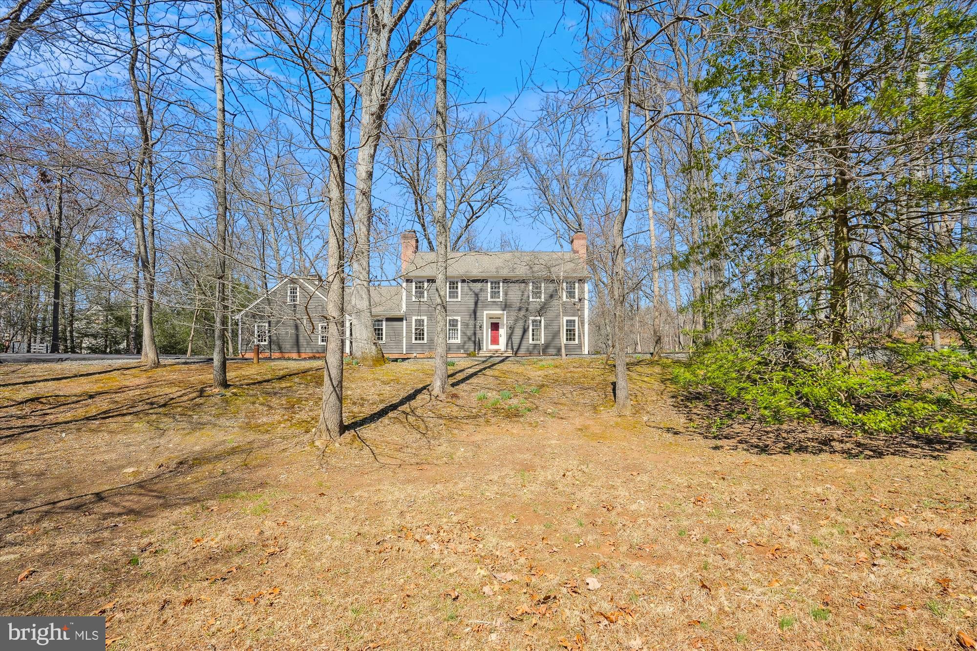 Stunning New England Style  4 BR, 3.5 Bath Colonial with finished walkout basement on  2.9 Wooded Acres backing to a Beautiful Stream! MANY IMPROVEMENTS  in recent years including: Hardie Plank Siding, Timberline Architectural  Shingle Roof, Gutters, Soffit, Paved Circular Driveway, Garage Doors and Stone walkway to front door. The Interior  Updates include:  freshly painted throughout all 3 levels, refinished  hardwood floors on the main & upper level, Refreshed Powder Room & Hall Bath  on Upper Level,  Brand NEW Frigidaire Propane Gas Cooktop in Kitchen,  Double Wall Ovens and some light fixtures and ceiling fan in Family Room. The back yard  has a gate and easy access to the woods  for the buyer looking for privacy and the  enjoyment  of a meandering stream! There are  FOUR wood burning Fireplaces, 3 on the main level and 1 in the lower level and detailed moldings throughout.   Being Sold in  AS IS Condition and priced appropriately, however  the house is in BEAUTIFUL  MOVE-IN READY CONDITION! Privacy, Serenity & Nature at it's Best!