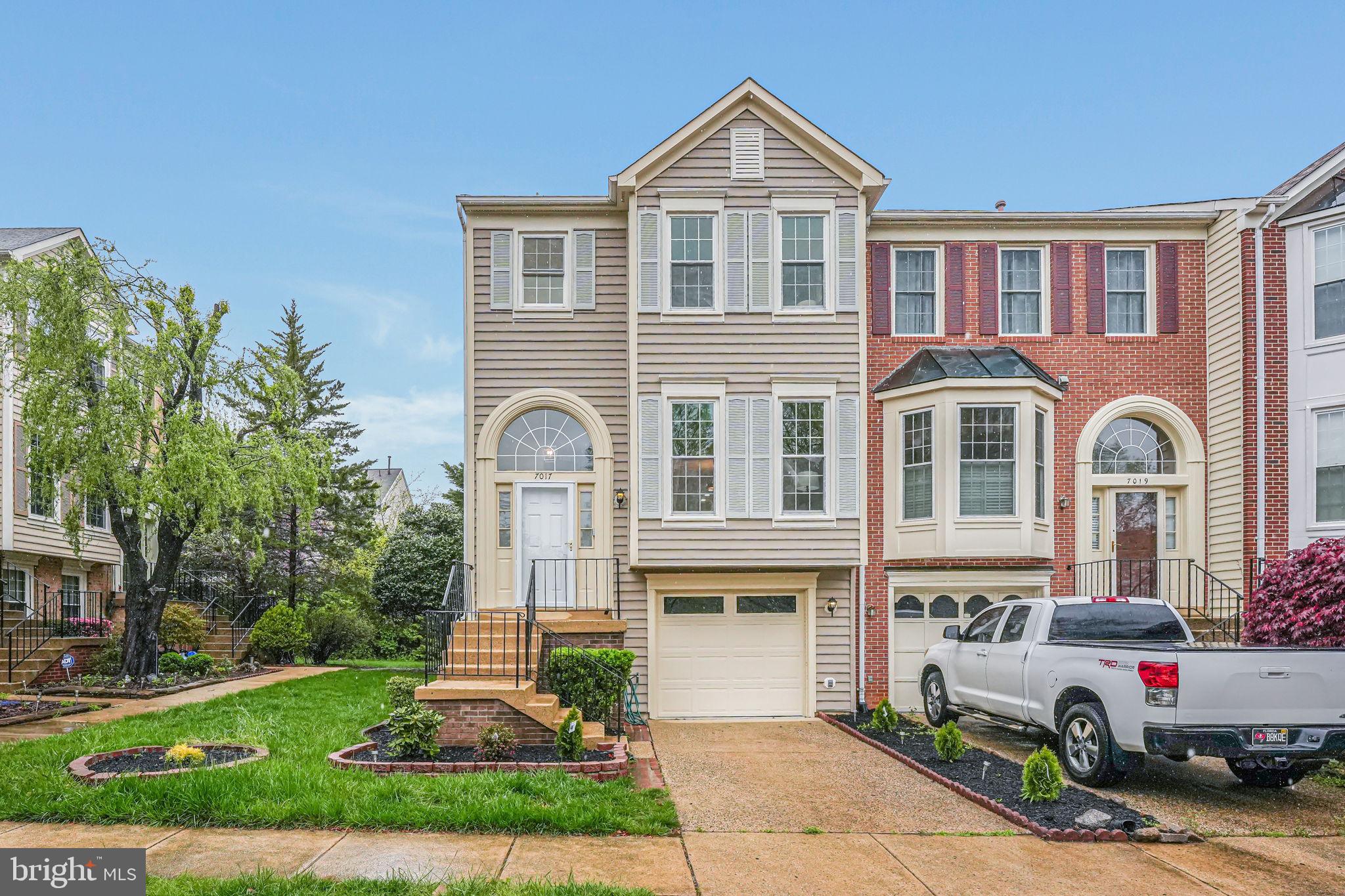 Bright, open, and abundantly spacious end unit townhouse in Kingstowne!  You'll love the separation of spaces on the main level. Full, cartwheel friendly living room, step up to the dining area and into the rear facing kitchen.  New stainless steel appliances are here and ready for your meal preps! New refrigerator with ice maker, new garbage disposal, and stove.  Bar overhang for your casual stools for breakfast dining with coffee or tea.  Family room area with gas fireplace plus extra windows for more natural sunlight.  Sliding glass door with oversized elevated deck backing to trees for extra outdoor privacy, ready for summertime grilling.  Upper level has three bedrooms.  Primary bedroom has vaulted ceilings, deluxe bath with separate soaking tub, separate shower, and double vanity.  Lower level is finished as a separate 4th bedroom living area with full closet, full bath, and wet bar.  Walkout level to patio and fenced in low maintenance yard. Ideal for a separate home office, recreation room, or suite for your overnight guests!  Garage parking and enjoy all of the amenities of Kingstowne!