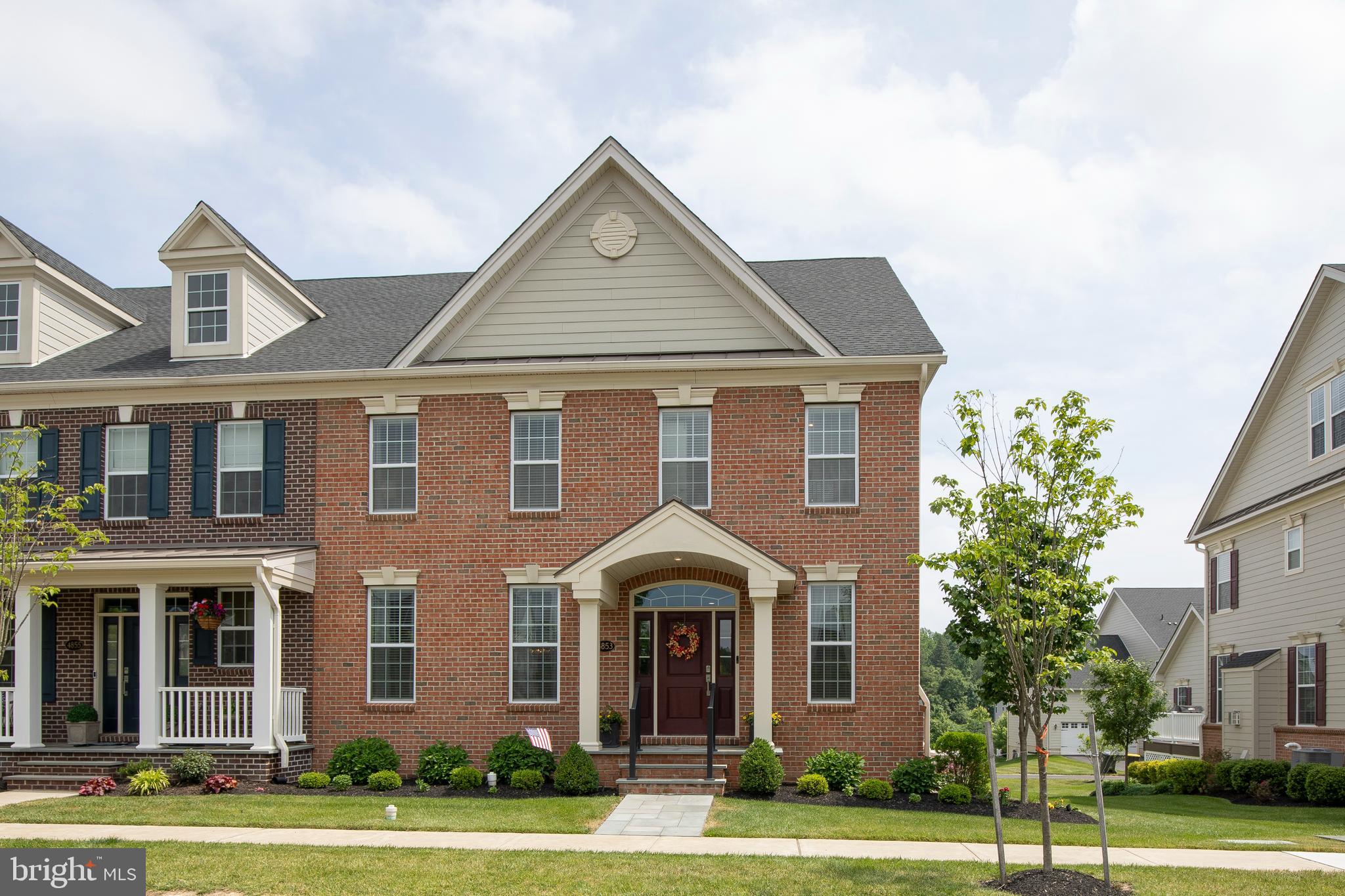 Nestled in the highly sought-after Fenton's Corner community, this exceptional Carriage House showcases luxury living with extensive custom upgrades and impeccable attention to detail. From the moment you arrive, the charming flagstone front portico sets the stage for the elegance that awaits inside.
The stunning open-concept main level features white oak hardwood flooring throughout, sophisticated crown molding, and custom gray wainscoting that enhances the dining area. At the heart of the home is a chef-inspired gourmet kitchen, complete with quartz countertops, a striking charcoal center island, abundant cabinetry, upgraded stainless steel appliances, a hands-free faucet, reverse osmosis water dispenser, a spacious glass-door pantry, and a sunny breakfast nook.
Flowing seamlessly from the kitchen is the bright and inviting family room, highlighted by a cozy fireplace and custom shiplap accent wall. The main floor also offers a beautifully appointed powder room with custom tile and wainscoting, as well as a generously sized laundry room featuring extensive cabinetry, a utility sink, and additional storage closet.
A graceful staircase with wood treads and wrought-iron balusters leads to the upper level. The luxurious primary suite offers a welcoming entry area, cathedral ceiling, ceiling fan, and a custom California Closet. The spa-like primary bath features rich walnut cabinetry, leathered granite countertops, a beautifully tiled oversized shower, a private water closet, and a linen closet.
Two additional spacious bedrooms with ample closet space share a stylish hall bathroom with custom tile finishes and a convenient double-door linen closet.
The professionally finished lower level is designed for both entertaining and everyday enjoyment. A fully equipped kitchenette includes built-in cabinetry, granite countertops, sink, beverage refrigerator, microwave, and a large island with seating. A custom shiplap feature wall and electric fireplace create a warm and inviting gathering space, while a dedicated fitness room powder room and multiple storage areas add functionality.
Outdoor living is equally impressive, with an upper-level composite deck perfect for cocktails and relaxation, and a lower-level stone patio offering additional dining and seating areas. Beautiful custom landscaping, stone retaining walls, and thoughtfully designed outdoor spaces create a private backyard retreat.
Additional premium features include a Generac whole-house generator, exterior low-voltage LED landscape lighting with timers, water treatment system, sprinkler system, security system, and much more.
Ideally located between the charming boroughs of Doylestown and New Hope, residents enjoy scenic walking paths, open green spaces, and picturesque surroundings. The home is served by the highly acclaimed Central Bucks School District.