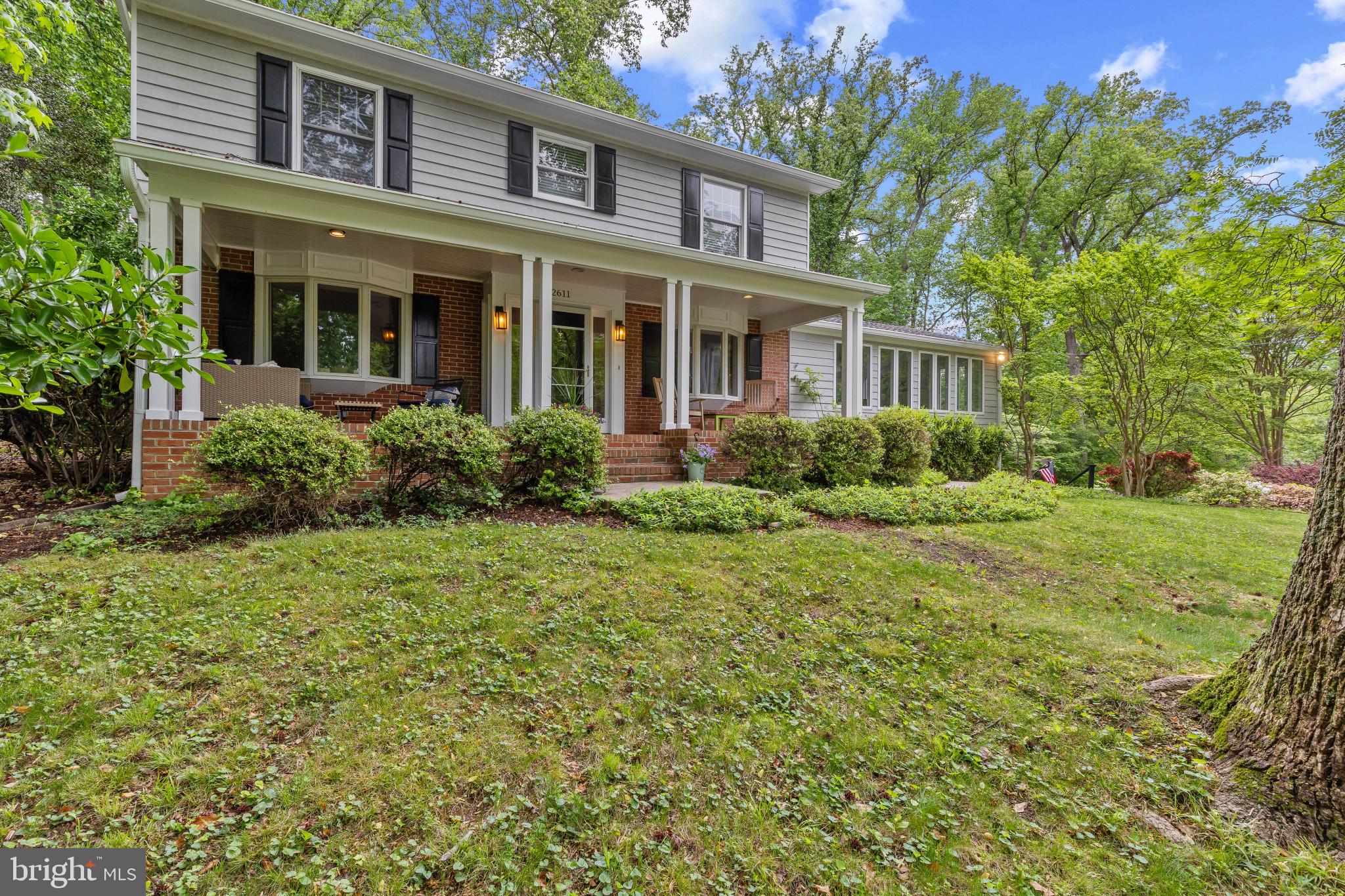 Tucked among mature trees in the sought-after community of Annapolis Roads, this exquisitely remodeled home is a true showpiece where every design detail has been artfully curated to create a warm, sophisticated and effortlessly livable retreat. A beautifully crafted covered porch with rich wood flooring offers a striking introduction to the home. Inside the home, gleaming hardwood floors, rich moldings, designer lighting and thoughtfully selected finishes create an elevated yet welcoming atmosphere throughout. Beautifully renovated and impeccably maintained, the home blends timeless architecture with refined modern style. The elegant dining room features a bay window and flows seamlessly into the stunning gourmet kitchen through a convenient pass-through. Designed with both beauty and function in mind, the kitchen showcases inset cabinetry, leathered absolute granite countertops, designer backsplash, stainless steel appliances with gas cooktop, a casual dining area and a sophisticated wet bar. The adjoining family room is filled with natural light from oversized windows that frame the wooded setting, while custom built-ins with inset cabinetry create a seamless connection between the living spaces. Just beyond, the screened porch, with skylights and ceiling fan, opens to a beautiful rear deck overlooking the fenced backyard and lush landscaping. A formal living room with a wood-burning fireplace and bay window, chic powder room and private main-level office with French doors complete the thoughtfully designed main level. Upstairs, the serene primary suite offers two closets and a beautifully updated ensuite bath with glass-enclosed shower. Two additional bedrooms and a stylish hall full bathroom complete the upper level. The lower level provides ample storage and endless possibilities for additional living space, recreation or fitness area, along with convenient garage access. Perfectly sited to enjoy the best of Annapolis Roads, the property offers access to an exceptional waterfront lifestyle. Residents enjoy a sandy beach with sweeping Chesapeake Bay views, waterfront pavilion, playground, firepit, community dock, boat ramp, walking trails through Ogleton Woods and numerous community events. Nestled between Lake Ogleton and the Chesapeake Bay, Annapolis Roads is known for its winding roads, wooded lots and abundance of preserved green space and water access. There is no HOA — the community operates as a special tax district with fees included in the property taxes. Ideally located just minutes from downtown Annapolis, shopping, dining and major commuting routes.