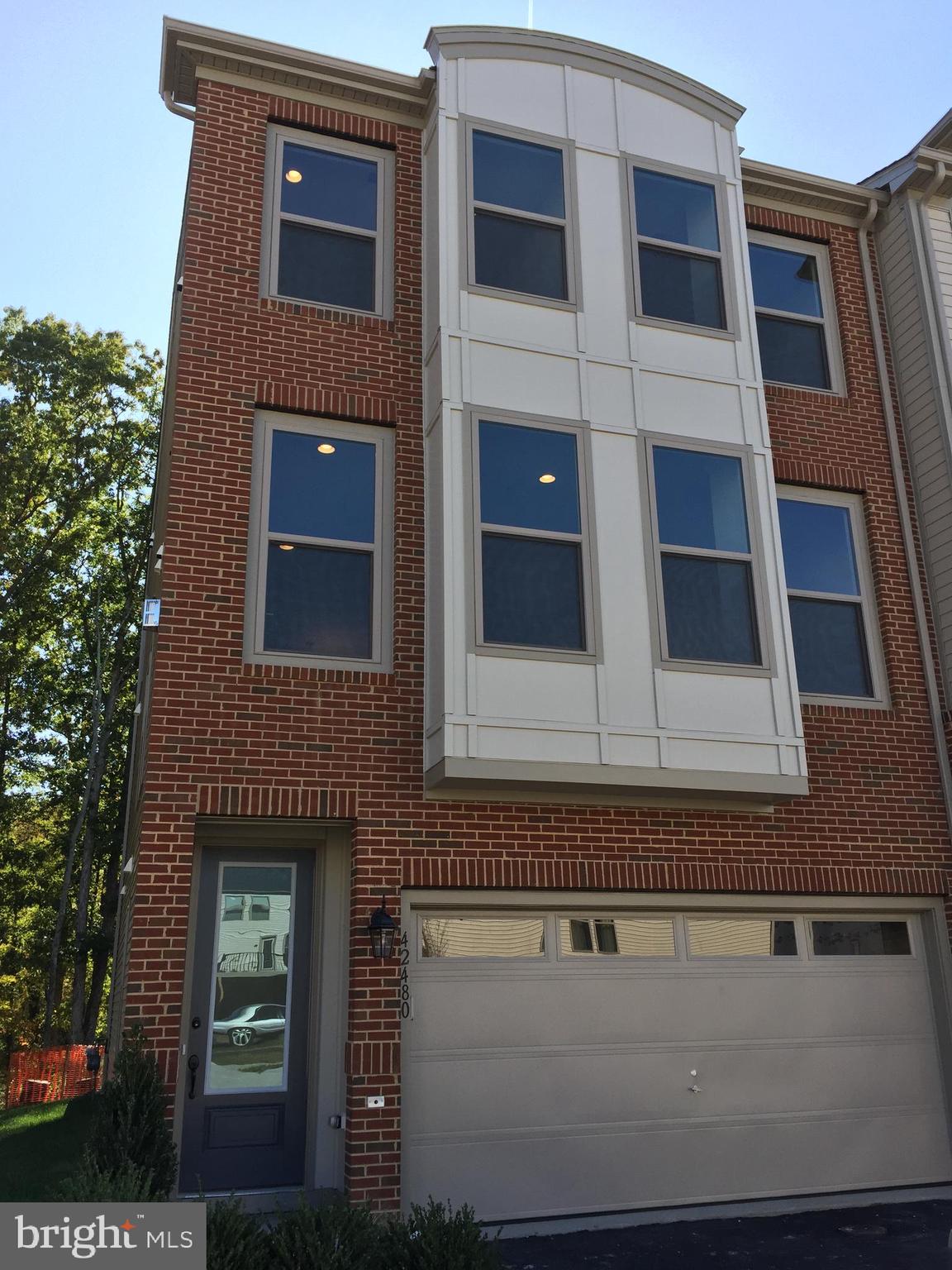 This spacious home in the Stone Ridge community has it all! Stunning 3 Bedroom 3.5 Bathroom end unit Townhome. The owner's suite with walk-in closets provides ample storage space. The Main level includes a fireplace, a gourmet kitchen with quartz counters, stainless steel appliances, a gas cooktop with exhaust, a large island, and a huge deck outside. The lower level is a versatile space, complete with a full bathroom, making it an ideal large entertainment area, playroom, or home office to suit your needs. Additionally, there are huge storage racks in the attached 2-car garage for all your storage needs. The backyard faces the woods with lots of open space. Amazing community amenities, great schools - Elaine E Thompson ES/Mercer MS/John Champe HS. Opposite Stone Springs Hospital, and close to Harris Teeter, Walmart and other shops, Dulles airport, and much more. Pet ownership is considered on a case-by-case basis. A lot of visitor parking spaces in front of the home.