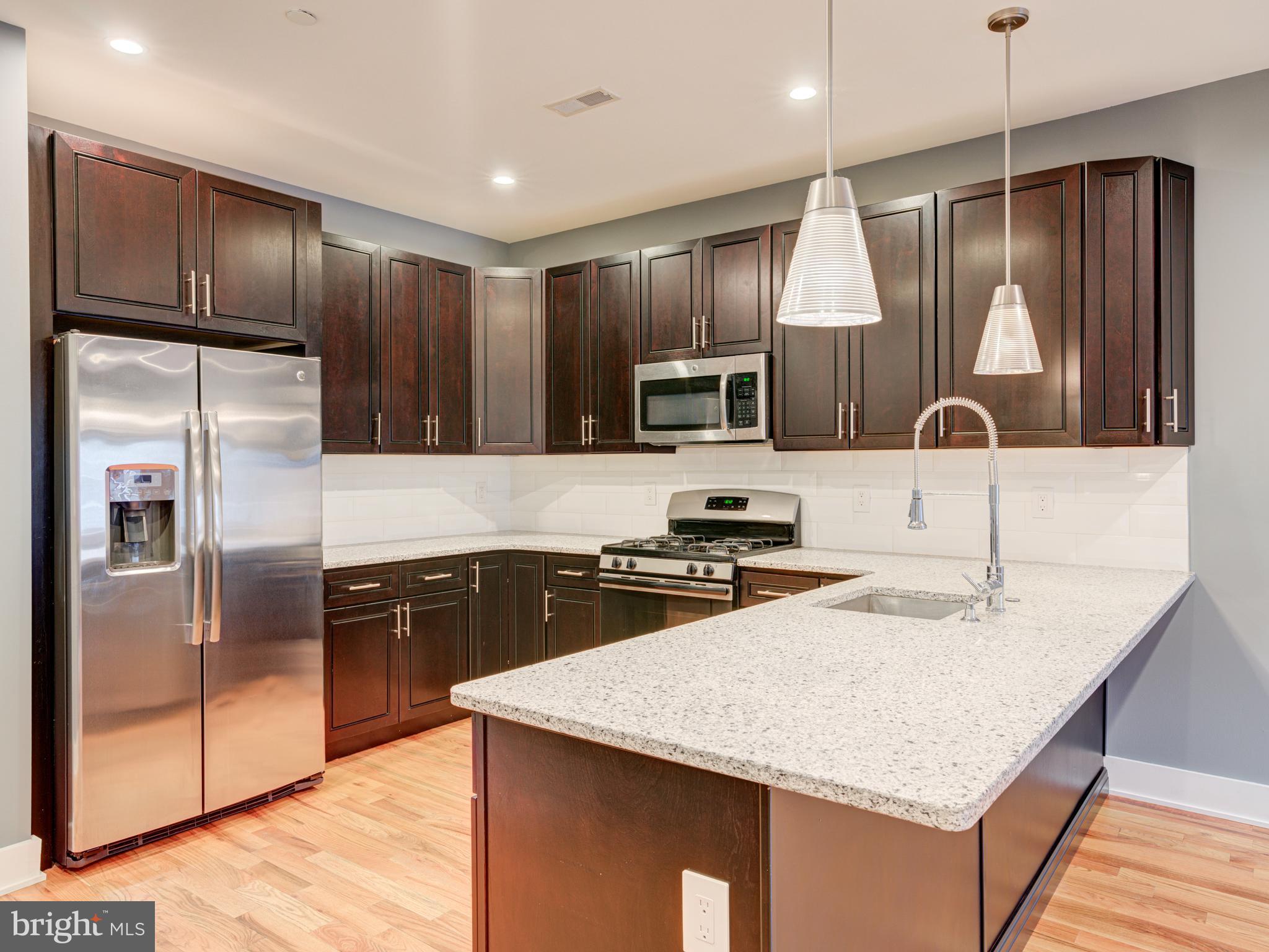 BEST location in South Kensington / Norther Liberties with PARKING and ROOF-TOP DECK !   Welcome to this stunning 3-bedroom, 3 full-bath custom-designed luxury condo in South Kensington, steps away from HOT Northern Liberties and walkable to Fishtown  — all three being of Philadelphia's most vibrant neighborhoods.  This is your chance to own a condo (which feels like a house) with private and coveted PARKING in the rear (surface space) with the huge benefit of affordability having approximately three years remaining on a tax abatement. Special features include a video doorbell system, a NEST thermostat, a cathedral ceiling, and custom blinds throughout. The open-air design creates a seamless flow between the spacious living, dining areas, and kitchen, with stunning oak hardwood floors, recessed lighting, and ceiling fans. The living room features a highly efficient fireplace, perfect for cozy winter evenings with modern open space. The chef’s kitchen is equipped with stainless steel appliances, an elegant quartz countertop, abundant cabinet space, and a breakfast bar. The first floor boasts a large bedroom and a full bathroom with exquisite ceramic tiles and a stylish vanity. Upstairs, the second floor features two generously sized bedrooms with ample closets, two full bathrooms with modern ceramic tile designs, and a master suite with a walk-in closet, a glass-door shower cabin, and a double vanity. A convenient utility room with a full-size washer and dryer is located next to the master bedroom. Take the stairs to your private roof-top deck, the perfect space to amazing city views, entertain guests, or watch 4th of July fireworks. Additional perks include a dog park conveniently located in the rear, easy access to public transit with a 10-minute walk to Girard Station (Market-Frankford Line), and proximity to the trolley and bus routes 47 and 57. The condo’s prime location has a walk score of 95, placing you near the restaurants, bars, and shops of Fishtown and Northern Liberties, with quick access to I-95 and I-676, and only a 1-hour, 10-minute train ride to New York City.     The Layout is ideal for roommates as each bedroom has its own full bath or for the couple with kids or just wanting that private home office or guest bedroom.  Don’t miss this rare opportunity to own a stylish condo with every amenity you need. Schedule your appointment today to view this extraordinary home  as it is vacant and easy to show !
