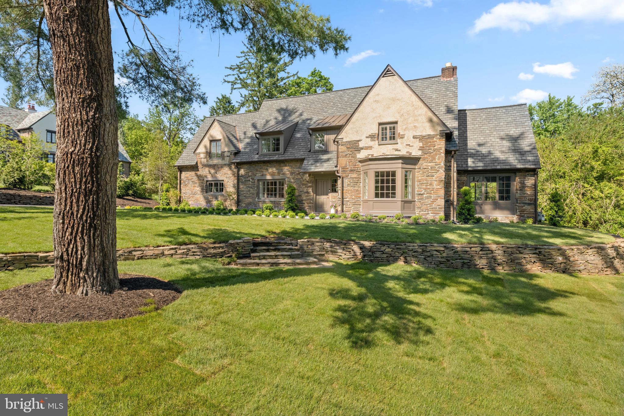 Welcome to 519 Sussex Road, where you'll  immediately fall in love with this exquisitely reimagined custom residence by the renowned builder, Rayer Sexton Homes. This exceptional residence has been fully reframed and renovated with the finest craftsmanship, materials, and finishes.  Situated on of the most desirable streets in Wynnewood, this home is situated on picturesque .43 acre lot of professionally landscaped grounds and boasts 4 bedrooms, 5 full bathrooms, and 1 half bathroom.  Thoughtfully renovated from top to bottom, this home blends timeless elegance with modern luxury, offering space for both entertaining and every day living. The entire home is drenched in natural light flowing through the brand new Anderson 400 series casement windows.   Wide plank white oak hardwood floors flow through the first and second floor adding warmth and timeless sophistication.  The home's lighting has been curated with top of the line fixtures at every turn by designers Visual Comfort and Hinkley.  Enter the home down a brand new bluestone walkway.  The first floor welcomes you with a gracious foyer.  To the right is a large formal living area with a gorgeous fireplace and custom cabinetry, and entry to the bluestone rear patio.  Directly off the living room is an office/study, also featuring custom cabinetry.  To the left of the foyer is a formal dining room, featuring an additional custom-built bar/buffet with a beverage cooler perfect for entertaining and holiday gatherings.  At the heart of the home, the gourmet kitchen and open concept family room are both striking and functional.   Stunning Calcutta Aura Quartz countertops, custom Goebel cabinetry and hood,  Thermador appliances (including a built-in refrigerator and dishwasher), and a six-burner range beautifully anchor the space.  Adjacent to the kitchen is an open-concept family room with custom built-in cabinetry.  This whole area has been set up with speakers for surround sound.  Close to the kitchen area, there is another door that has access to the back patio for entertaining. The main floor is complete with a powder room.   There is also a back door for everyday entry, next to the one car attached garage.   Step inside this area and you will find an extra large coat closet, and a mudroom area with built in cubbies.   Ascend up the stately stairwell the second floor, with the primary ensuite bedroom, and three additional large bedrooms, and a full laundry room.  The luxurious primary ensuite bedroom is complete with a large walk in closet, and spa like bathroom with a his and hers vanity, a large shower and a private water closet.  The three additional bedrooms also have their own ensuite bathrooms!  One of them includes a bathtub.  The finished lower level with luxury vinyl flooring includes an additional 1200 square feet of living space.  A large portion of this lower level is living space with a custom built in bar, and custom cabinetry.  The other finished space is designated for a home gym or wellness area.  The lower level is complete with another full bathroom.    The systems in the home are also completely brand new including a complete rewire and plumbing, a five zone HVAC with two high efficiency systems (gas heating) and new hot water heater.  The home is crowned with a brand new roof featuring a premium Grand Manor 50 year shingle, offering the refined appearance of simulated slate and exceptional durability.  The outdoor living area shines with a large blue stone patio, and a private flat rear yard with beautiful plantings, sure to be your own private oasis!  Located in the award winning Lower Merion Schoo District and close to many private schools, country clubs, shopping, dining, and major highways to Philadelphia, New York, and beyond - this spectacular home offers convenience, luxury, and Main Line living at its best.