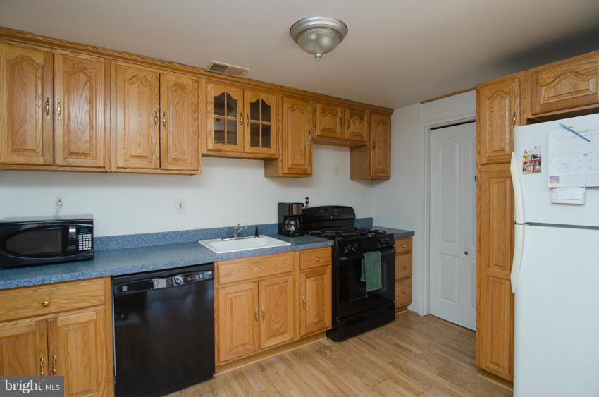 REDUCED  Priced to sell NOW!!  Owners found home of choice. Over 2100 Sq. Ft of living space. Updated kitchen, fire place with cathedral ceilings, new carpet, and wood floors.There is a separate in-law apartment with another full kitchen, living room, bedroom with full bath, and separate entrance. Fenced yard with mature trees, 2 sheds, and above ground pool.