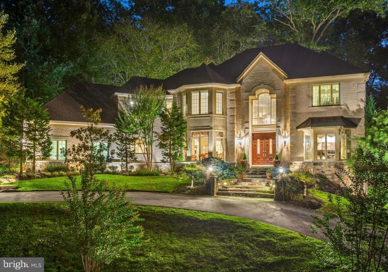 Nestled behind a conservation easement of trees  hidden off Bradley,  this magnificent 6500+ living square foot residence is surrounded by mature trees and lush greenery. A striking two-story grand foyer sets the tone for elegance, flanked by formal living and dining rooms designed for refined entertaining. The sunken family room is a showstopper—anchored by a stunning limestone tile fireplace. The heart of the home is the gourmet chef’s kitchen, appointed with top-of-the-line stainless steel appliances, rich cabinetry, and an expansive island. A  breakfast area overlooks a tranquil waterfall fountain and beautifully hardscaped stone patio—perfect for al fresco dining and outdoor gatherings. A main-level en-suite bedroom, powder room, mud-room and a private home office offer both comfort and convenience. Upstairs, the lavish primary suite is a true sanctuary, complete with a gracious sitting room and two oversized walk-in closets. Three additional generously sized bedrooms with two bathrooms and laundry room round off the upper level. The finished walkout lower level offers exceptional versatility, featuring a spacious recreation room, full bathroom, and endless potential for entertaining or multi-generational living. Generous size storage rooms. Impeccably maintained and thoughtfully designed, this home offers timeless luxury and modern comfort in a setting that feels worlds away—yet is just minutes from everything. 3 car garage with plenty of parking on driveway and on circular driveway in front of home. Winston Churchill School Cluster.  All offers due Tuesday (8/5) at 1pm.