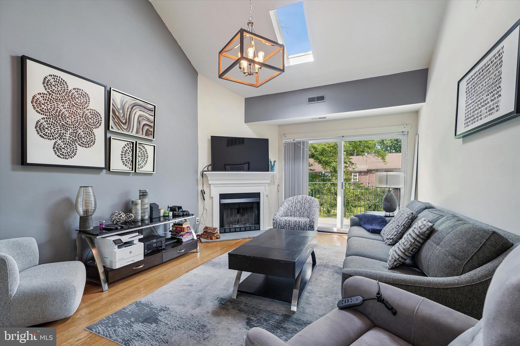 Imagine a place where your weekends are spent enjoying brunch in Bryn Mawr, grabbing a coffee from La Colombe, strolling through the neighborhood, or catching the SEPTA Regional Rail into Center City instead of spending hours cutting grass, shoveling snow, or worrying about exterior maintenance. Welcome to Mayflower Square, where comfort, convenience, and the Main Line lifestyle come together.

As you step inside, natural light immediately welcomes you. Sunlight pours through the oversized sliding glass doors while the skylight brightens the living space throughout the day, creating a warm and inviting atmosphere that feels open and airy. As the seasons change, picture yourself unwinding beside the wood burning fireplace, a feature that sets this home apart from many other condos.

Slide open the doors to your private balcony overlooking the beautifully maintained courtyard. It's the perfect place to begin your morning with a cup of coffee, enjoy a quiet evening after work, or simply take in the peaceful surroundings.

The updated eat in kitchen features a charming garden window that brings even more natural light inside, creating a bright and welcoming space to prepare meals. A convenient powder room allows guests to have their own private space, while the in unit washer and dryer make everyday living effortless.

The spacious primary bedroom comfortably accommodates a large bedroom set and overlooks the courtyard, offering a peaceful retreat at the end of the day. A generously sized second bedroom provides flexibility for a guest room, home office, or additional living space. Between the bedrooms is the full bathroom, and additional storage is available through the pull down attic access. Neighboring unit has even demonstrated expansion possibilities, subject to association approval and buyer verification.

Outside, you'll enjoy the convenience of an assigned garage parking space with automatic opener, helping protect your vehicle from summer heat, winter snow, and rainy days, along with an additional assigned parking space conveniently located near the garage door

One of the greatest advantages of living at Mayflower Square is the lifestyle. This is not a massive high rise condominium where you feel like just another unit. Instead, you'll enjoy a smaller community while being just moments from everything that makes Bryn Mawr one of the Main Line's most desirable destinations. Walk to Bryn Mawr Village, neighborhood restaurants, boutique shopping, La Colombe Coffee, Bryn Mawr College, the SEPTA Regional Rail, and enjoy easy access to Center City Philadelphia and nearby Villanova University.

Condominium living also means more freedom. The monthly association fee includes water, sewer, trash, snow removal, lawn care, exterior building maintenance, common area maintenance, management, and master insurance, allowing you to spend less time maintaining a home and more time enjoying life, whether that means traveling, dining out, or simply making the most of everything the Main Line has to offer.