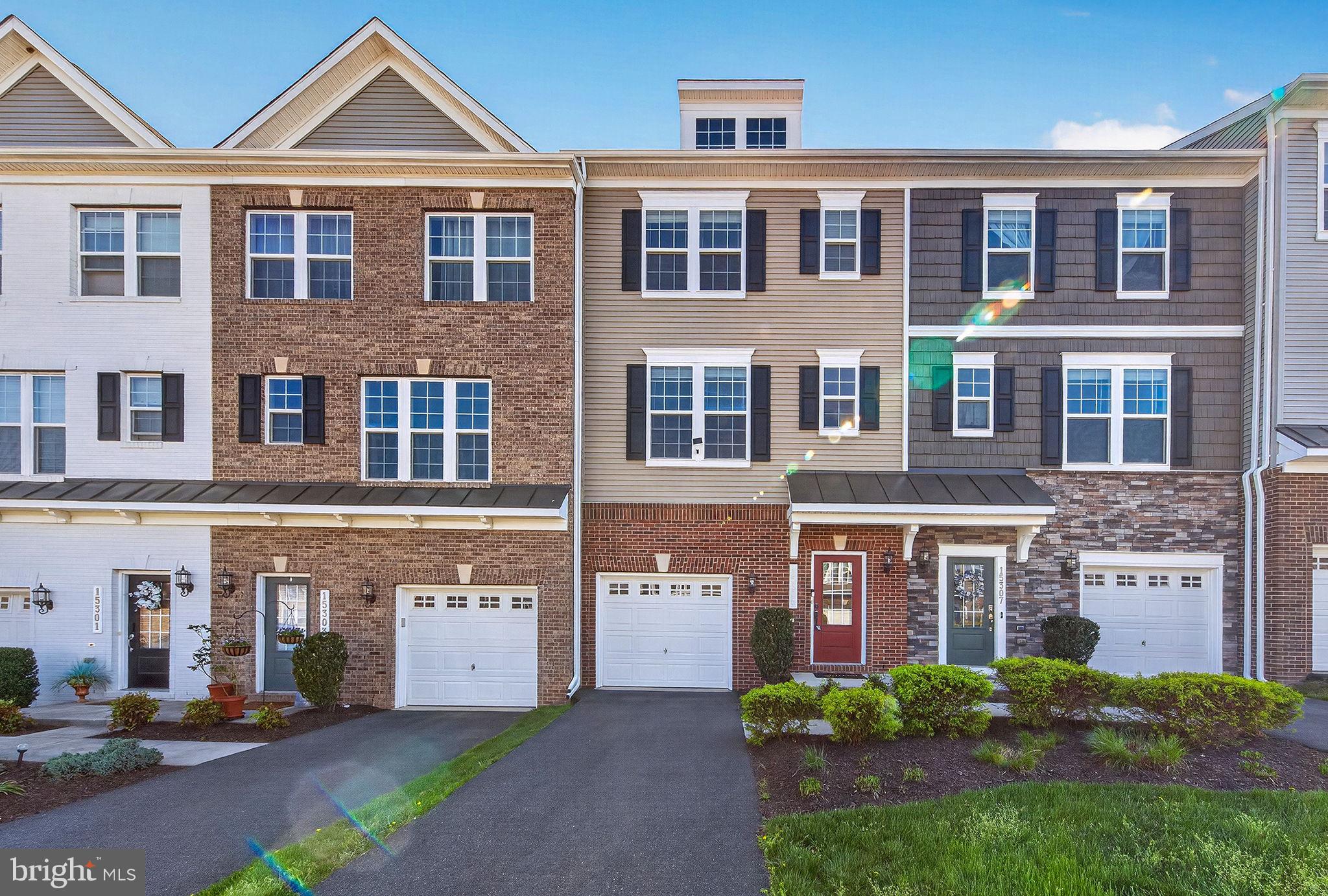 Welcome to 15305 Linville Creek Dr, a beautifully maintained, move-in ready townhome-style condominium in the highly sought-after Haymarket Crossing community. Boasting 2,133 square feet of refined living space across three finished levels, this 2017 brick-front property features an expansive open floor plan that has been elevated with brand-new flooring installed throughout all three levels. The main level is highlighted by pristine, newly laid floors and filled with abundant natural light streaming through large double-pane windows. The gourmet kitchen serves as the structural focal point, equipped with stone countertops, a large central prep island, an integrated pantry, stainless steel appliances, a double wall oven, and a built-in microwave. Seamless indoor-outdoor connectivity is achieved via sliding glass doors that lead directly to a spacious rear deck, offering an ideal space for outdoor relaxation. The upper level features a thoughtful dual-suite configuration, offering two large primary bedrooms, each complete with a dedicated walk-in closet, brand-new carpet underfoot, and an attached full bathroom. A brand-new, front-loading washer and dryer set is also conveniently located on this bedroom level. The entry-level lower floor provides exceptional versatility, hosting a private third bedroom with fresh new flooring and its own full bathroom, making it a perfect arrangement for guest accommodations or a quiet home office layout. Freshly updated with new interior paint alongside the comprehensive flooring upgrades, this residence also includes a 1-car attached front-entry garage with an inside entrance and additional storage solutions. Located just minutes from critical transit corridors including Interstate 66, Route 29, and Route 15, commuting from this location is exceptionally efficient. Residents will enjoy immediate proximity to premium community infrastructure and amenities, including the Wegmans Food Market in Gainesville, the sprawling retail and dining options at Virginia Gateway Shopping Center, Walmart, Starbucks, and comprehensive medical services at the nearby UVA Health Haymarket Medical Center. Outdoor recreation is readily accessible at nearby Silver Lake Regional Park. The monthly association structure delivers a true low-maintenance lifestyle, covering exterior building maintenance, front, side, and rear lawn care, snow removal, water, and sewer services.