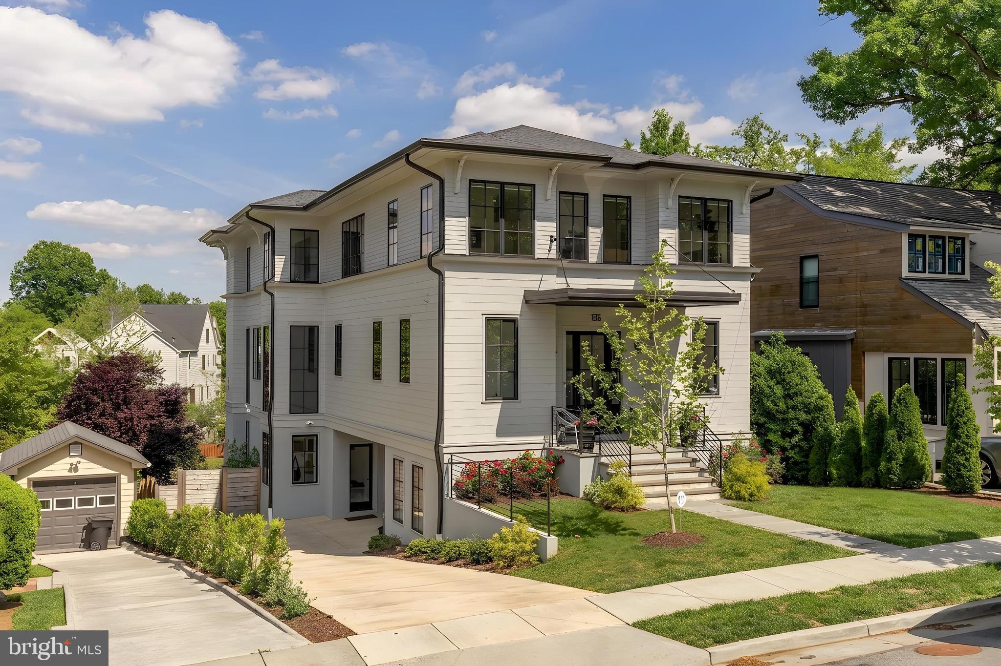There is new construction in Lyon Park — but there is nothing quite like this.
From the moment you step through the front door, 135 N Edgewood announces itself. A gracious entry foyer opens into a beautiful hallway that draws your eye all the way to the back of the home, where floor to ceiling windows pour light through the entire main level the kind of first impression that stops you mid-step. This is not a house that reveals itself slowly. It lets you see exactly what it is, right away.
The main level is both elegant and livable in equal measure. A dedicated office or flex room sits just off the entry, quietly tucked, completely functional. A powder room. And then the formal dining room, anchored by a designer light fixture that makes the space feel considered and special without taking itself too seriously. Beyond that, the home opens fully: a chef’s kitchen flowing into an everyday dining area and a generous family room, all of it connected and light-filled, designed for the way life actually moves. Off the back, a screened porch perches above the yard - an elevated, beautifully finished outdoor room that blurs the line between inside and out in the best possible way. On a warm evening, with the doors open and the light fading, there is truly nowhere else you would rather be.
Upstairs -Light floods the upper level, where a beautifully appointed lounge area greets you, a natural gathering space that anchors the floor before the bedroom wing unfolds. Three secondary bedrooms, each with its own ensuite bath, feature the kind of tile and finish selections that feel custom & considered rather than off-the-shelf - soaking tubs, unique tilework, fixtures chosen with a real point of view. And then the primary suite, which is genuinely in a league of its own. Walls of windows, extraordinary light, a massive walk-in shower, a freestanding soaking tub, a double vanity, and two closets wrapped in finishes that make the room feel like a destination rather than just a place to sleep.
The lower level at grade, bright, and fully open to the outdoors, it functions as a complete extension of the home-  a large family room and entertaining area, a fifth bedroom, and a full bath, all flowing out to an expansive deck and a backyard that simply keeps going. Beyond the property line sits a private neighborhood park, adding a layer of open green space and natural beauty that no amount of landscaping can replicate. It is the kind of backdrop that makes you exhale every time you look at it.
A garage plus a driveway that handles multiple cars with ease. And tucked privately away, a fully separate home office and workout space with its own powder room and its own entrance. For anyone who works from home, runs a business, or simply values the ability to close a door between work and life, this space is a genuine differentiator. It offers the autonomy of an entirely separate suite without ever leaving the property.
Lyon Park itself deserves a word. This is one of Arlington’s most beloved and established neighborhoods:  walkable, connected, and rich with the kind of community energy that makes people move here and never want to leave. Clarendon’s celebrated dining, shopping, and nightlife are minutes away on foot. Commuter routes and Metro access make the broader DMV effortless to navigate. And the neighborhood itself - tree-lined, architecturally rich, genuinely walkable provides the kind of daily quality of life that is increasingly hard to find this close to the city.
Custom construction with finishes that have to be experienced in person to be fully appreciated.
There is new construction in Lyon Park. And then there is this.