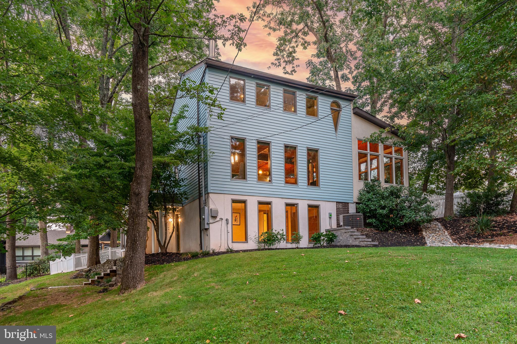 On a beloved block that’s so close to so much, this custom-designed dwelling has been thoughtfully expanded to create an open-concept floor plan that will make your heart sing. Bumped out and expanded, a great room was created, forming a captivating space that blends the gourmet kitchen, dining, and living areas into one harmonious expanse. Towering red oak ceilings infuse the space with warmth, while a wall of windows allows natural light to flood in, highlighting the exquisite craftsmanship at every turn.  A modern gas stove in the great room invites you to relax.  Gorgeous hardwood flooring with 4 fireplaces creates much appreciated character and style. Chefs and entertainers alike will love the dream-come-true kitchen with stainless appliances, a center island, complete with seating for six, a work sink, a beverage fridge with ice maker, a stainless-steel farm sink, a 4-burner gas cooktop, grill and hood vent, a wall oven, convection oven/microwave, warming drawer, fridge, dishwasher and even a wine fridge.  With three bedrooms spread across different levels reached via custom rough-sawn staircases, this home offers an abundance of privacy. The spacious main bedroom, offers a cozy wood burning fireplace with outdoor deck access for those morning coffees in the fresh air, will surely indulge with an ensuite bathroom boasting an oversized rain shower, a sumptuous soaking tub, double commodes, and a bidet and double sinks. On the third floor, the generous second bedroom with its own en-suite bath, private sitting area and ample closet storage provide another private retreat having a gas fireplace for chilly nights.  The ground floor beckons you to unwind and relax in the spacious family room, complete with a crackling fireplace. This level also has a third bedroom, with a wall of windows and a built-in Murphy bed, that could also be used as a home office and adjacent full bath.  The fenced backyard oasis promises endless enjoyment throughout the seasons. Take a dip, relax or work out in the oversized swim spa and gather around the outdoor fire place as the evening sets in when not enjoying the vibrancy of New Hope’s nightlife.  A very special community and all just a short walk to the many award-winning restaurants, shops, The Bucks County Playhouse, The Delaware River and over the bridge into charming Lambertville.