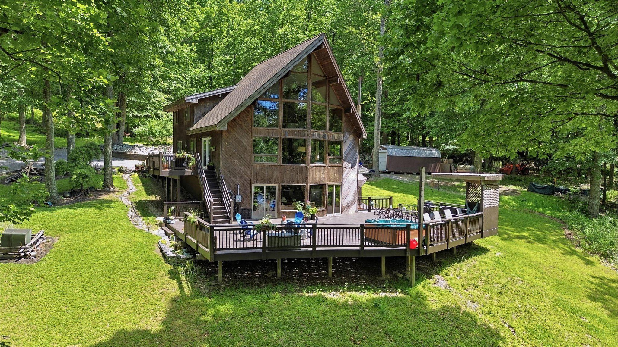 Escape the subdivision life for a residence defined by scale, privacy, and rugged utility. Set on 32.39+/- acres, this cabin-style estate is built for those who want their permanent home to feel like a fortress of solitude without sacrificing modern comforts. The interior features a recently updated kitchen equipped with new appliances and granite countertops. While there is a propane furnace, there is also a classic woodstove that provides a high-efficiency heating source and a focal point for the entertainment area in the basement. The home’s footprint is anchored by an expansive rear deck designed for four-season use; whether you’re hosting or decompressing, the integrated hot tub offers total privacy, screened by a dense canopy of mature timber to create an outdoor living room that feels completely removed from the outside world.

This isn't just a woodlot; it's a gateway. The property borders Gambrill State Park, providing exploration and recreational opportunities right out your back door. For the serious outdoorsman or the family seeking an active lifestyle, the land offers endless utility for hiking, scouting, and wildlife management. The long, wooded approach ensures a level of seclusion and security that is increasingly rare, making this an ideal primary residence for those seeking a quiet, secure environment.

Practicality meets potential inside and out, with a walkout basement that provides the ideal entertainment area or can be converted into a home office, gym, or additional bedrooms to grow with your needs. An existing shed provides organized storage for ATVs and maintenance equipment, keeping your primary living spaces clutter-free. Shown by appointment only, this is more than a getaway—it is a rare opportunity to own a significant piece of acreage with your ideal mountain retreat on your own recreational land in the Catocin Mountains.