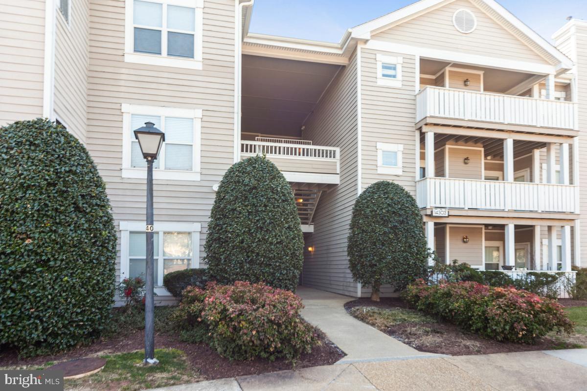 Welcome to this beautifully maintained 2-bedroom, 1.5-bath condo in the highly sought-after Sanderling community! This spacious home features an open floor plan that seamlessly connects the foyer, living room with a cozy fireplace, dining area, and kitchen. Large windows fill the space with natural light, creating its warm atmosphere. The generous primary bedroom includes a walk-in closet, while the private balcony off the living room offers the perfect retreat to relax and unwind. Enjoy the many amenities this community has to offer, including a clubhouse, fitness center, outdoor pool, hot tub and more. Stroll through the beautifully landscaped common areas, surrounded by lush lawns, flowering trees, and a tranquil pond. For added convenience, residents and guests have ample parking, with one assigned space located right in front of the building, as well as a storage room just steps away from the condo. Conveniently situated near major routes, shopping, dining, a movie theater, and more—this condo is the perfect place to call home!