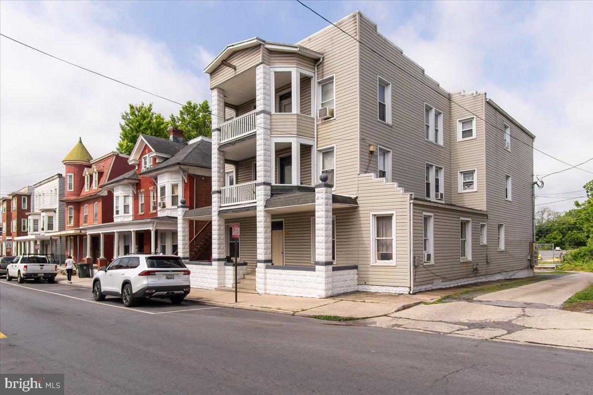 Excellent opportunity to add a well-maintained six-unit multifamily property to your investment portfolio. Each spacious unit offers 3 bedrooms, 1 full bath, a central living room, eat-in kitchen, and covered rear porch, with second and third-floor units also enjoying access to private front porches. The property has been consistently maintained and features recent exterior improvements including fresh paint and a new front entry door. A shared coin-operated laundry facility provides additional income potential, while the rear parking area offers off-street parking for approximately eight vehicles. Ideally situated in a prime Hagerstown location, the property offers easy access to public transportation, downtown amenities, schools, Meritus Park, shopping, dining, and major commuter routes. All units are separately metered for electricity, with tenants responsible for their own electric usage, including heating, hot water, appliances, and lighting. Water and sewer expenses are largely passed through to tenants based on occupancy. Five of the six units are currently rented on month-to-month agreements, providing a new owner with significant flexibility and immediate opportunity to increase rents toward market levels. Current ownership has maintained high occupancy while keeping rents below market, offering investors a rare opportunity to increase revenue without major renovations or repositioning. Current rents are below prevailing market rates for comparable three-bedroom units, creating substantial upside potential through future rent adjustments. Whether you're looking to expand an existing portfolio or acquire a turnkey asset with value-add potential, this fully occupied property offers strong cash flow, desirable unit sizes, and long-term investment appeal.