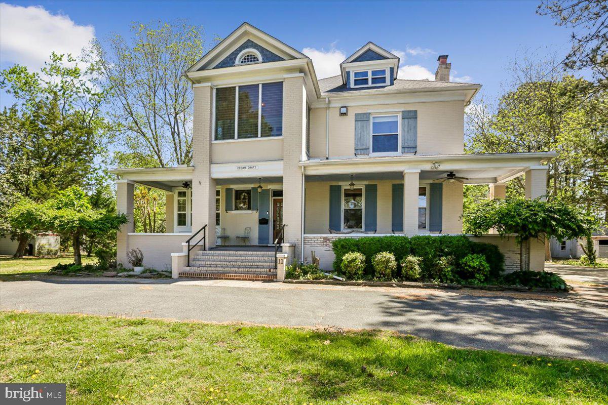 Step into timeless charm with this stunning all-brick home set on a spacious 1.49-acre lot in Crisfield known as Cedar Croft. Connected to city water and sewer, this property blends historic character with modern comforts in all the right ways. From the moment you arrive, the large wraparound front porch sets the tone—perfect for relaxing and taking in the surroundings. Inside, you’ll find soaring 10 ft ceilings on the first floor and 9 ft ceilings upstairs, creating a bright and airy feel throughout. The home showcases incredible craftsmanship with six oversized pocket doors, beautiful moldings, exquisite trim work, and original hardwood floors that add warmth and character. The gourmet kitchen is a true centerpiece, featuring a historic brick fireplace, granite countertops, and top-of-the-line cabinetry. Just off the kitchen, the butler’s pantry offers even more convenience with additional granite counters and a wine refrigerator—perfect for entertaining. The spacious primary suite provides a cozy retreat with its own marble fireplace, while the guest bathroom in the hall is thoughtfully designed with a glass shower and whirlpool tub. An enclosed sleeping porch off one of the guest bedrooms adds a unique and charming touch. The finished third floor, serviced by a ductless HVAC system, offers additional flexible living space—ideal for a home office, guest area, or hobby room. A basement provides even more storage or utility space. Outside, you’ll find plenty of room for storage and hobbies with a detached 2-car garage and two additional sheds, all set on a generous lot offering privacy and space to enjoy. This one is packed with character, space, and functionality—truly a rare find in the quaint coastal town of Crisfield.
