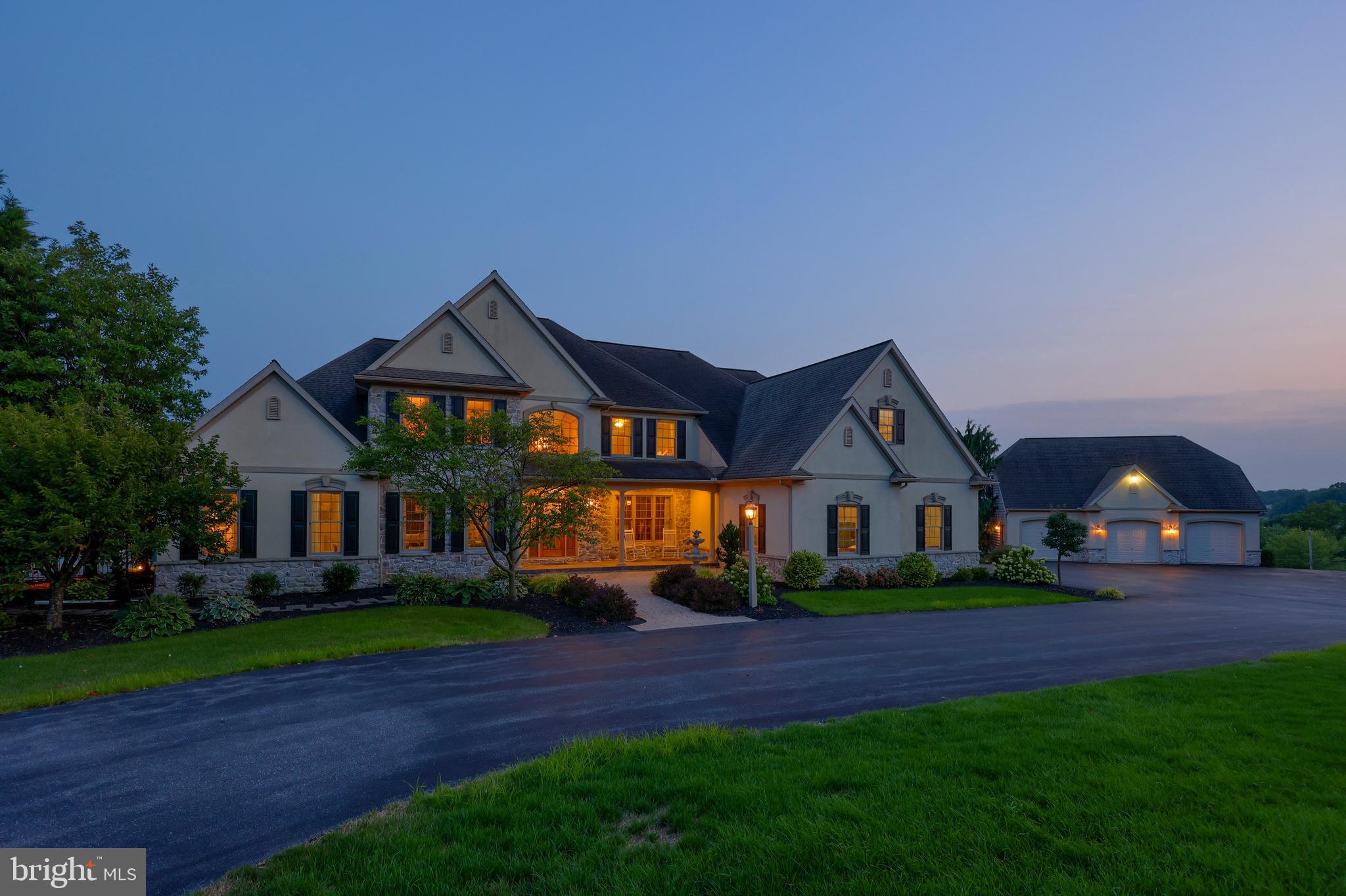 Welcome to 1409 Diamond Station Road, a custom-built estate set on 13.42 acres offering over 8,300 sq ft of living space. This exceptional home features 5 bedrooms, all with walk in closets. Additional unfinished bedroom on 2nd floor, 5 full bathrooms, and 1 half bath, including a first-floor primary suite with a spacious bath and walk-in closet. The main level offers a two-story foyer, formal dining room, living room or office, a large Manny Beiler custom kitchen with granite countertops, island seating, walk-in pantry, sunroom, and a family room with soaring, coffered ceilings and gas fireplace. The finished lower level adds over 2,600 SF with a home theater, kitchenette, full bath, possible bedroom or office, additional living space, and private entrance. Outdoor highlights include a large Sylvan, heated, concrete pool with expansive patio, pool house with kitchen and bath, detached 3-car garage, pasture area, and tillable farmland. Anderson 400 series windows. Enjoy peaceful country living with easy access to Routes 272 and 222, all while taking in breathtaking Lancaster County farmland views.