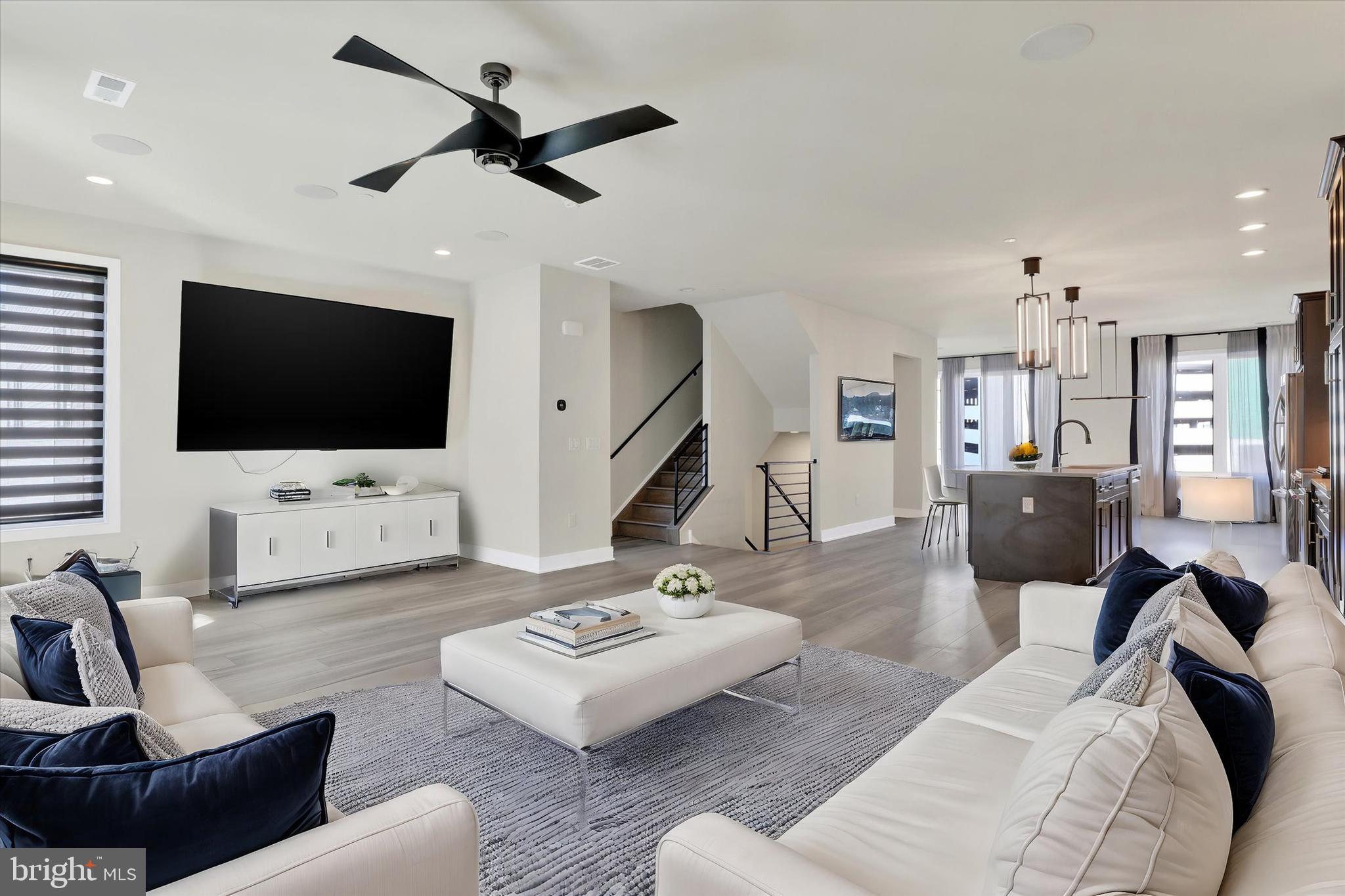 Experience the Best of Luxury Living without the Wait! This immaculate 2-year-old Better then NEW, Spacious, Contemporary End Unit Carriage Home at Overlook at Town Center in King of Prussia offers low-maintenance elegance with Upgrades Galore—including five mounted flat-screen TVs and rooftop furniture and TV! With a bright, open-concept layout and high ceilings, every detail is designed to create a refined and inviting atmosphere. The gourmet kitchen is a chef’s paradise, featuring quartz countertops, stainless steel appliances, ample cabinetry, a pantry with sliding doors, and more. The main floor boasts a spacious living area, dining space, home office, additional alcove, built-in wall unit, powder room, and a covered balcony with remote-controlled blinds. Upstairs, unwind in the serene primary suite with tray ceilings, a private balcony, a luxurious ensuite bath, and a large walk-in closet. Two additional bedrooms, abundant storage, a hall bath, and a convenient laundry room complete the upper level. An expansive rooftop deck provides over 1,000 sq. ft. of outdoor living with panoramic views, including Valley Forge National Park. The home also includes a one-car garage for parking and extra storage. Enjoy upscale dining, shopping, and a full-service gym within walking distance, along with easy access to I-76, I-476, Routes 422, 202, and the PA Turnpike. Seller is Motivated! “Special Financing Incentives available on this property from SIRVA Mortgage.”