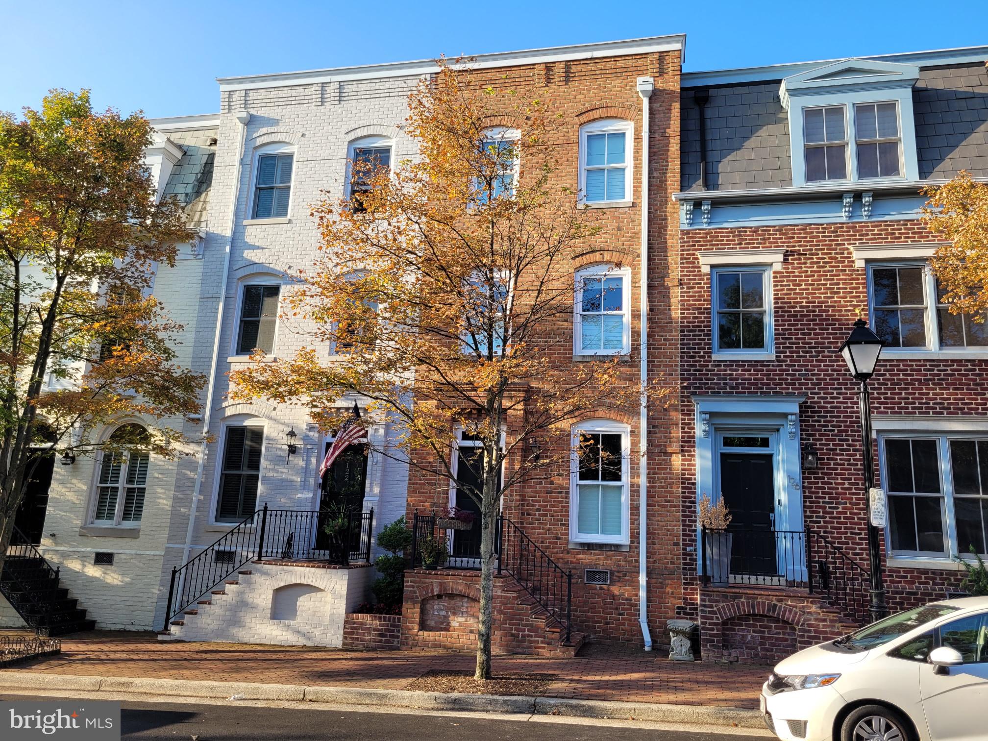One of the most beautiful blocks in Old Town!!!  This terrific Queens Row townhome is just steps to Founders Park and has front porch river views!!!   Amazing, gorgeous upgrades throughout the home including gourmet kitchen with white cabinetry, marble counters, stainless steel appliances, glass backsplash and recessed lighting.   Remodeled primary bath with frameless glass shower, white cabinetry, dual sinks and designer tiles.  This elegant home has the amenities sought-after in active and fun Old Town.... three bright and open levels, hardwood floors, crown molding, ten-foot and twelve-foot ceilings, two gas fireplaces, built-in cabinetry, large room sizes, and a full en-suite bath for each of the three bedrooms.  There is a sunny rear bay window, transom windows, skylights and even two assigned parking spaces!!!  You and your guests are greeted by a brick walkway and brick front porch that opens to an extended foyer and its classic wood staircase.  The amazing kitchen has tall top-quality cabinetry and LG appliances including a French door refrigerator and five-burner gas stove.  Off the kitchen is a sitting area / breakfast room that has crown molding, 6-inch baseboards and a large window with wood shutters.  The formal dining room has hardwood floors, a newer contemporary chandelier and extensive moldings.  The living room welcomes everyone with a gas fireplace, hardwood floors, built-ins, recessed lighting and a four-section French door with transom windows opening to the south-facing, fully-fenced Travertine patio with built-in gas grill.  The primary suite has a wall of closets plus a generous walk-in closet.  It has hardwood floors, 12-foot ceilings, the second gas fireplace, recessed lighting, a charming bay window and its primary bath that has been completely upgraded to a luxurious oasis!!!  The second bedroom has hardwood floors, a double closet, two windows and has its own updated bath with six-inch tiles and newer mirror / lighting.  The sunny bright upper staircase with one of two skylights takes you to the top level and the third bedroom with its own full upgraded bath.  Also on this upper level is a terrific office/den area with the second skylight and a family room with a dormer window overlooking the city's roof tops.  The laundry room has enclosed cabinets, white appliances and offers an extended storage area.  The zoned gas furnace and gas hot water heater are both tucked away on this level.  This gracious home is in the middle-of-it-all!!!  There are extensive dining options nearby that are both formal and relaxing.  Catch the trolley to enjoy all of King Street's offerings or have an evening of fun on a dinner cruise.  The riverfront parks and walkways are seconds away.   Your Old Town adventure begins here!!!