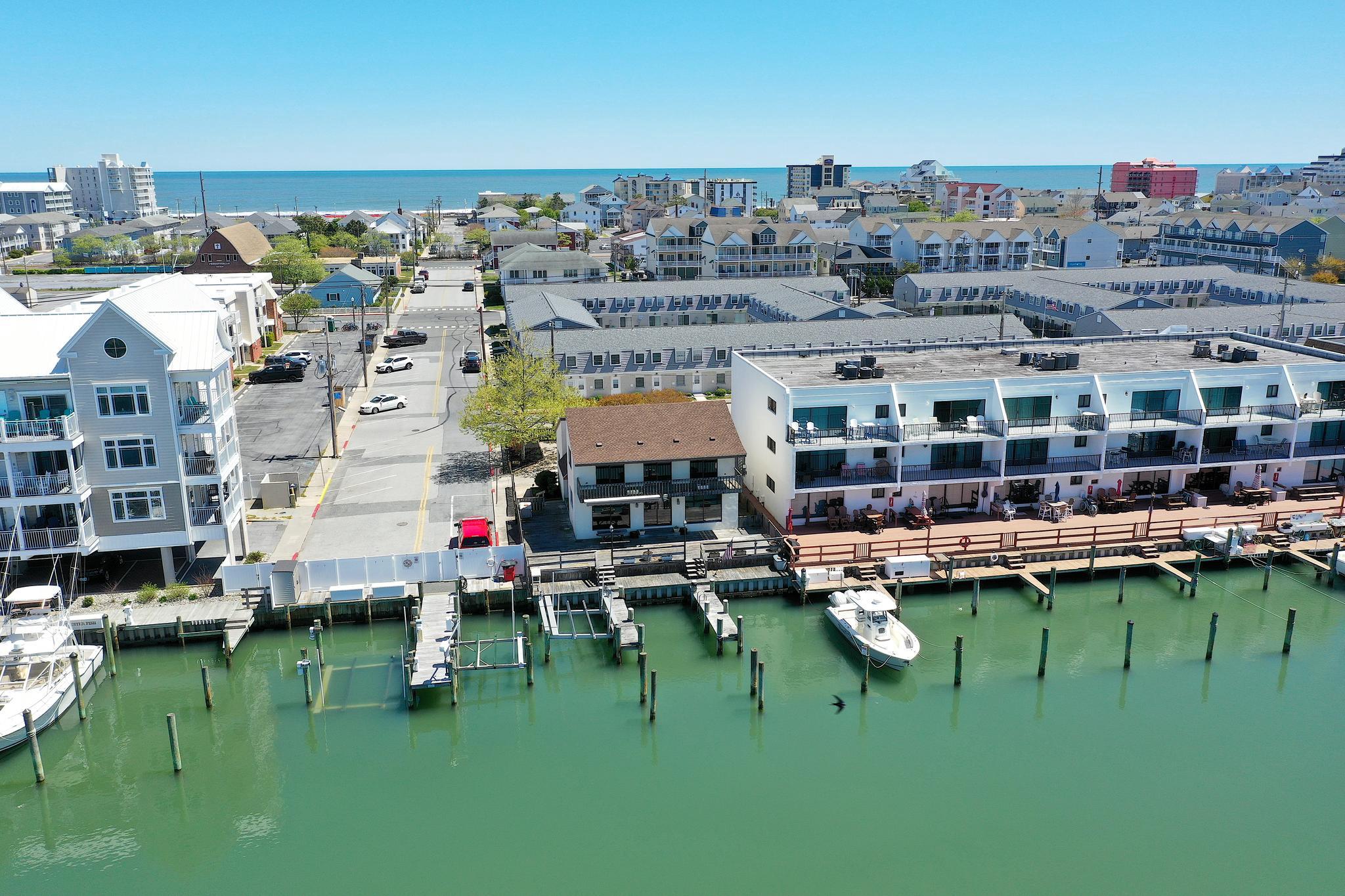 RARE WATERFRONT OPPORTUNITY WITH ENDLESS POTENTIAL! NEWER VINYL BULKHEAD! 
This is truly a one-of-a-kind waterfront property nestled on an oversized 6,000 sq ft lot overlooking the protected cove of Harbor Island. Opportunities like this are incredibly rare—offering not only location, but unmatched versatility and potential.
The existing over 2,000 sq ft two-story home invites you to bring your vision to life. Whether you choose to renovate and customize the current residence or explore the potential to build two units (with town approval)—living in one and renting the other—the possibilities here are exceptional.
Boating enthusiasts will appreciate the 3 private boat slips, including one with an electric lift, along with over 40 feet of water frontage complete with water and electric at the dock. Enjoy direct access to open water while being tucked into a calm, protected cove—perfect for boating, fishing, or simply relaxing by the water.
Enjoy gorgeous nightly sunsets while entertaining family and friends on your large private deck after a day on the water. Prefer the beach? You’re just a short walk away from putting your toes in the sand.
This location is truly a WATERMAN'S DREAM, offering endless opportunities for fishing, boating, swimming, and even front-row seats from your own deck to watch the excitement of the annual White Marlin Tournament, including the boats returning, weigh-ins, and all the energy this iconic event brings.
Skip the beach traffic altogether—just hop on your boat and cruise to the many waterfront restaurants and bars along the Ocean City bayfront for dining, drinks, and entertainment.
Why pay condo or HOA fees when you can own your very own piece of waterfront paradise? This property offers the freedom, space, and flexibility that’s hard to find in today’s market.
This home is being sold “As Is”, presenting a rare opportunity to secure a premier waterfront location and make it your own.
The world is your oyster with this Harbor Island gem—don’t miss an opportunity like this again!