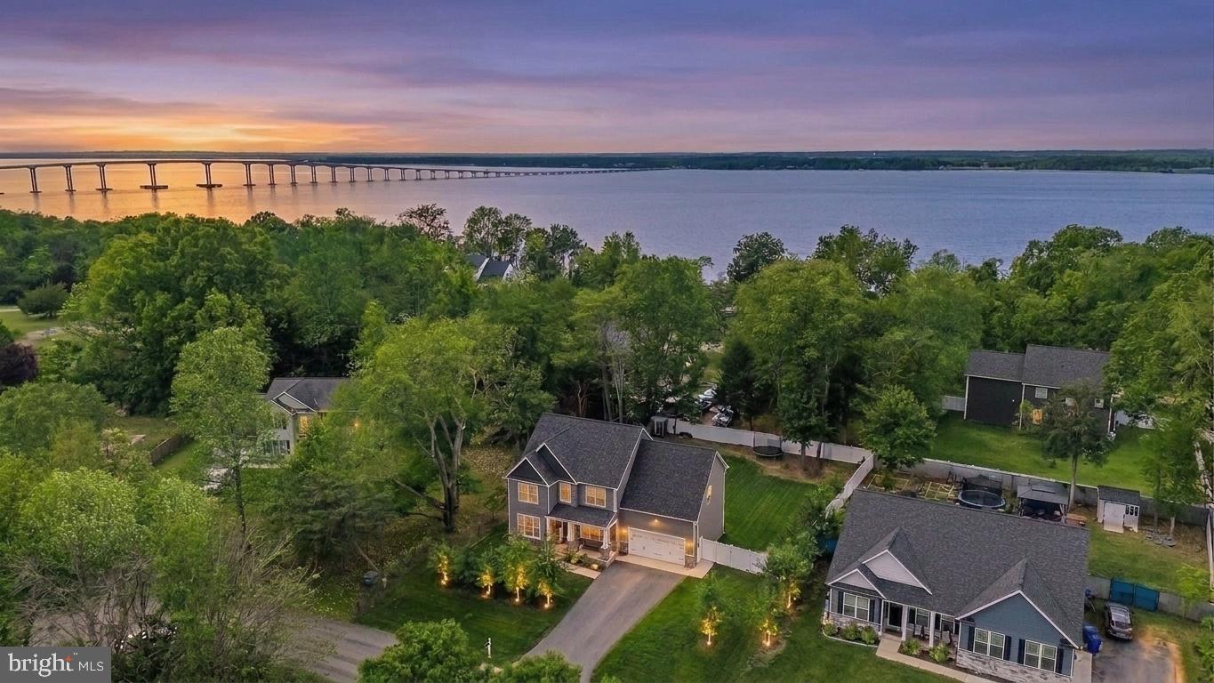 ASSUMABLE RATE OF 2.99% for eligible VA buyers. Available for a quick close and immediate occupancy! Beautifully designed Craftsman-style home, built just 4 years ago. This home has seasonal waterviews of the Potomac River with water access just down the street at Aqualand Marina and Campground . This home offers plenty of space for everyday living, entertaining, and relaxing. Step inside to a bright and inviting floor plan. The family room flows seamlessly into the eat-in kitchen, featuring stainless steel appliances, granite countertops, custom cabinetry  and a charming breakfast nook.  A separate dining room provides the perfect setting for gatherings, while a private office offers a quiet space for work or study. Upstairs, the primary suite features a luxurious bathroom with a soaking tub, fully tiled walk-in shower, and large walk-in closet. Convenient laundry access is available from both the primary bathroom and hallway. Three additional bedrooms and a full bath complete this level. The fully finished basement adds ample living space, including a recreation room, flex area perfect for a home gym or guest suite with a full bath. The exterior showcases beautiful landscaping and curb appeal. A door off the kitchen leads to the spacious backyard, complete with a patio, sun sail for shade, shed and fully fenced-in yard — ideal for outdoor entertaining, gardening, or keeping pets. Located in the waterfront community of Cliffton on the Potomac with No HOA and No restrictive covenants. There is plenty of room to park an RV or boat in addition to the attached two-car garage wired for an EV (electric vehicle) hook-up. Numerous options for shopping and dining only 15 minutes to the Town of La Plata and 10 minutes to King George, VA via the new Harry Nice Bridge. Schedule your showing today! All inspections have been completed and are available saving you time and money! Ask for details about the assumable rate option!!