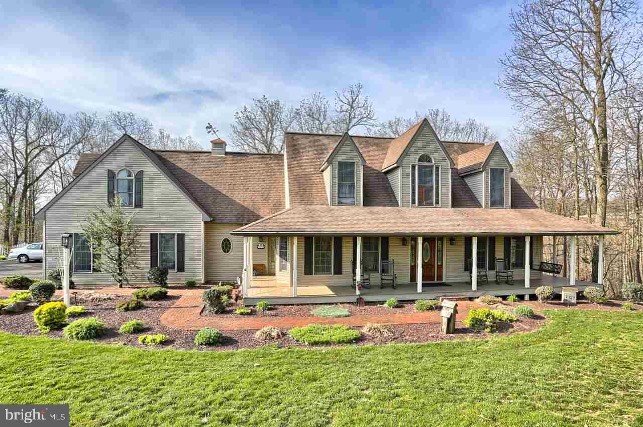 Come home to this pristine country manor! Pure perfection and privacy! Featuring private in-law quarters, beautiful wood floors in lg EIK w/brk bar. Cathedral ceil in LR, 9 ft ceil on 1st Flr, Spacious BRs upstairs, MB w/huge WIC. You'll love to enjoy the country serenity from either the rear maint-free deck & screen porch or covered maint-free front porch. Central Vac, 2 furnaces, huge basement waiting to be finished w/full BA. Exciting buy!