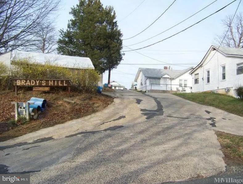 Investment opportunity in eastern Prince William County near entrance to Quantico Marine Base and National Museum of the Marine Corps. Currently known as Brady's Hill Mobile Home Park which has been in continuous use for over 60 years. Legal non-conforming use must be re-applied with Prince William County to guarantee number of pads which were 16 pad sites with several currently vacant. Five(5) single-family homes on the property ranging from 515 to 875 SF in size. Property sold in "As Is" condition. Land contains 2.68 acres of B-1 Commercial and some R-4 Residential. Long Range Land Use of this property is MU T-3 (Transect 3) which is intended for a variety of  commercial and residential uses expected to be up to four stories in height. This would require a re-zoning which Sellers may grant some rezoning time for a full price contract. Residential density is up to 12 du/acre (possible 32 units by right) and with T4 allowing up to 24 du/acre(max 64 units), which would also require a rezoning. Other uses is T3 include assisted living facility, brewery, or bottling facility, child care facility, dry cleaning/laundromat, funeral home, garden center, office and medical office, multi-family dwellings, recovery home, restaurant, townhouses, veterinary hospital, etc. Many of these rights are also permitted by-right in B-1 Commercial without rezoning, except for townhouses and multi-family.

Additional tax parcels: 8188-66-9032;8188-66-8735; 8188-66-9437; 8188-66-8941; 8188-66-9561; 8188-66-9339; 8188-66-9155; 8188-76-3145