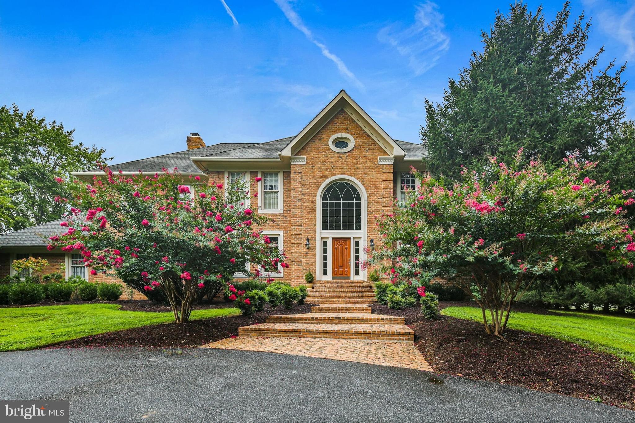 A truly special home located in the beautiful neighborhood of Buckskin Woods on expansive lot of nearly 4 acres.  Spacious living areas and high end finishes throughout including custom built ins, crown moldings, chair rail details, marble, ceramic and gleaming hardwood floors. Soaring ceilings add openess to classic traditional floor plan. Elegant entrance foyer, gracious formal dining room, dramatic sunlit living room and inviting family room complete with wet bar, cabinets, wine rack and under counter refrigerator. Main level also includes den/home office with adjacent full bath offering use as an additional bedroom. Bright chef's kitchen and breakfast room featuring premium cabinetry, quartz countertops and top of the line appliances including sub zero refrigerator.  Step outside to deck and gazebo overlooking heated pool surrounded by lush landscaping. Lighted tennis court adds to exceptional outdoor living experience.  Four bedrooms upstairs including luxurious master suite with fireplace and marble bath, two secondary bedrooms connected by a Jack-and-Jill bath while fourth bedroom has additional private full bath.  Lower level is designed for fun - home theater and theater lighting, recreational area accented by exquisite architectural details and stunning full service bar with granite countertops, refrigerator, dishwasher, cherry hardwood floors and even brass foot rails! An extra bedroom with full bath completes the space.  This home combines the best in family living with outstanding entertainment amenities. Everything needed to make lasting memories.