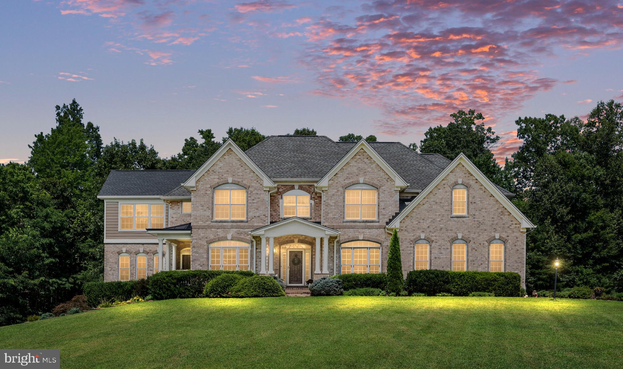 Welcome to an exquisite sanctuary where elegant architecture, meticulously maintained acreage, and exceptional outdoor living blend seamlessly into one extraordinary lifestyle. Nestled on over 12 sprawling acres, this custom all-brick traditional estate offers more than 6,400 square feet of refined living space, including 5 bedrooms, 3.5 baths, and timeless architectural detail throughout.
Surrounded by curated landscaping and total privacy, the property showcases breathtaking views of a fully stocked 1.25-acre pond, center 14ft deep, features grass carp, redear sunfish, bluegill, largemouth bass, catfish, and hybrid crappie. Enjoy endless outdoor recreation from the large floating dock which is perfect for fishing, swimming, sunbathing, or tying up the paddle boat, which stores conveniently in the charming boathouse. An elegant gazebo overlooks the water, creating the perfect setting for cookouts, quiet evenings, or stargazing by the pond.
The expansive backyard, framed by a lush treeline, includes a generous fire pit, storage shed, and ample space for a future pool. Two septic drain fields are thoughtfully positioned to the right side of the backyard (when facing the treeline). Additional exterior highlights include a three-car side-load garage, leaf-guard gutters, low-maintenance trim, and a whole-house generator. The upper-level morning room is finished in Hardie Plank siding, while the remainder of the home features classic brick construction.
Inside, a sophisticated yet welcoming interior awaits. A grand foyer with hardwood flooring is flanked by a spacious formal dining room—ideal for hosting holiday gatherings around an extended dining table. The living room is filled with natural light and captures serene views of the pond and side yard.
The open-concept gourmet kitchen features an island, abundant counter space, and a breakfast area perfect for casual mornings. Step outside to the patio for grilling, entertaining, or enjoying coffee while overlooking the peaceful treeline. Adjacent to the kitchen, the expansive family room with fireplace offers access to a covered terrace with tranquil pond views.
The show stopping morning room provides panoramic water views and an inviting space to relax year-round while watching loved ones enjoy the property.
Upstairs, a grand staircase leads to five bedrooms and three full baths, including a luxurious second primary suite complete with its own private morning room overlooking the pond, fireplace, dual closets, vanity area, and Jack-and-Jill bath. The main primary suite is equally impressive, featuring a large sitting area and spa-like en-suite bath with a garden soaking air tub, walk-in shower, dual vanities, and an expansive walk-in closet. The upper-level laundry room adds everyday convenience.
The unfinished lower level offers endless possibilities—design your dream media room, additional family space, kitchenette, full bath, recreation area, or private guest quarters. There is abundant storage, and the cabinetry in the storage area conveys.  The basement walkout provides direct access to the side yard with pond views.
Although privately set with a peaceful rural ambiance, the estate is just minutes from downtown Culpeper with convenient access to Routes 15, 29, and 3.  Other major shopping and dining areas are in Orange and Fredericksburg which are approximately 20-40 minutes away.   A unique historical note, the end of the court it connects to “Thomas Jefferson’s Road,” which is believed to have been traveled by Thomas Jefferson on his journeys to Washington, D.C.     14457 Kimber Lane is more than a home—it is a rare opportunity to own a one-of-a-kind estate in one of Virginia’s most picturesque settings!    See drone video