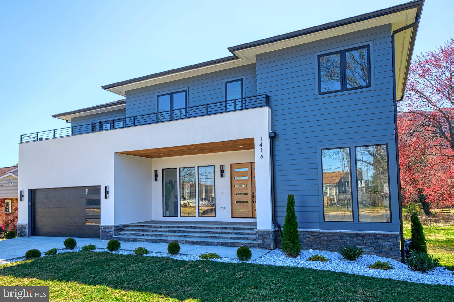 Welcome to this custom-built contemporary home, where luxury and functionality seamlessly converge. . Wrapped in a chic blend of HardiPlank and stucco, this masterpiece boasts over 5000+ (total) square feet thoughtfully crafted to provide a one-of-a-kind living experience.  
As you approach the stone front porch with its flagstone steps and rustic wood and glass double-door entrance, you'll know you're in for something special. The main level is impressive with its soaring 10-foot-high ceilings, hardwood floors, artistic light fixtures, and abundant natural light pouring in through the floor-to-ceiling windows. The eat-in kitchen, is truly a chef's dream, with ample quartz countertop space, a waterfall edge island, and contrasting two-tone cabinets that showcase meticulous attention to detail. High-end appliances such as a 36" range and refrigerator, drawer microwave, and large pantry, as well as a butler's pantry with a beverage refrigerator make this kitchen both beautiful and highly functional. Adjoining the butler’s pantry is the mud-room which is kitted out with built-in bench and cubbies.  Dining & Living room is dramatic with a double-sided fireplace which is a bold architectural masterpiece that not only adds warmth and ambiance but also elevates the overall aesthetic of the home. Moving upstairs, the upper level features 4 bedrooms, 3 baths and a laundry room. The  primary bedroom suite is the epitome of luxury, featuring a large walk-in closet, a delightful bath with a soaking tub, glass surround shower and a private W/C – and, to complete this exquisite space – a heated terrace!!The walk-out lower level of the home has been thoughtfully crafted to offer an array of amenities and features. For your creative side:  an arts and crafts area;  To host guests: a spacious ensuite;  To work out: an exercise den;  To unwind: a large recreation room complete with a wet bar and beverage refrigerator!