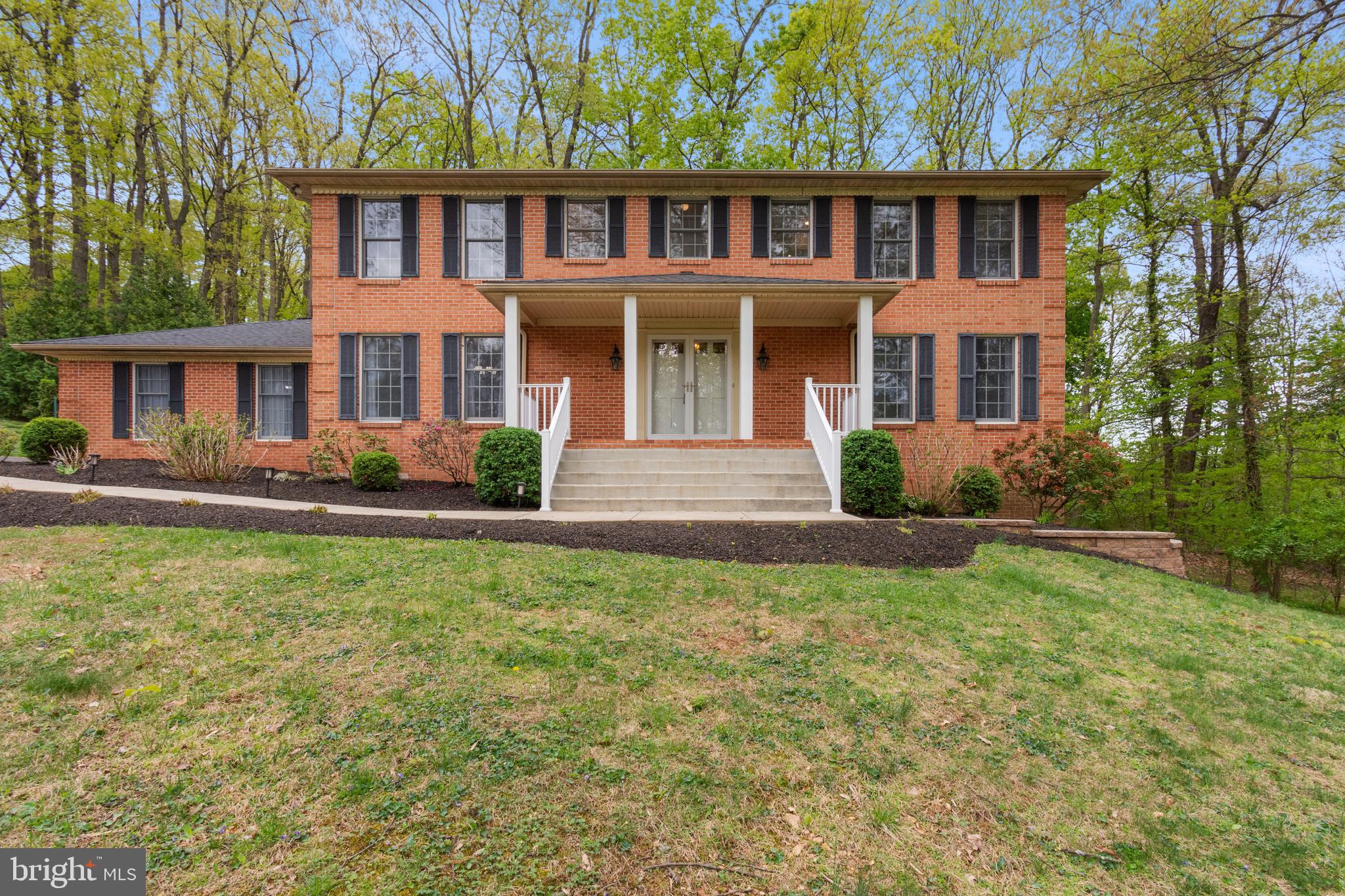 Price Improvement -This home is perfectly situated within 1.5 miles of the Taylorsville intersection at (Routes 27 & 26), with easy access to both Frederick and Eldersburg. Welcome home to this beautifully updated 4-bedroom, 2.5-bath brick-front Colonial with a lovely front porch! Tucked away on a peaceful wooded lot, this home offers a great mix of comfort, space, and modern updates. Step through the double front doors into a welcoming foyer with a convenient half bath. The main level features stylish luxury vinyl plank flooring throughout (except the powder room), giving the space a clean, updated feel. The recently remodeled kitchen is a true standout, featuring quartz countertops, stainless steel appliances, a stylish backsplash, bay window and recessed lighting—perfect for hosting friends and family. Just off the kitchen, the spacious family room offers a warm gathering space with a full-wall brick propane fireplace, wood mantel, and recessed lighting. A three-panel slider opens to a screened-in porch with a cathedral ceiling and ceiling fan, measuring 13' x 12', with additional adjoining decks (12' x 12' and 18' x 12')—perfect for relaxing or hosting outdoors. The dining room offers plenty of space for gatherings, complete with chair rail and crown molding, and the living room adds even more room to spread out, also featuring crown molding. Upstairs, you’ll find four very large size bedrooms, including a comfortable primary suite with its own wood-burning fireplace, a beautifully updated bathroom with a spa-like shower, and a walk-in closet. The lower level is ready for your ideas—whether you’re thinking about a home gym, movie room, or extra living space. If desired, the laundry room could be easily relocated to the lower level with hookups already in place. A slider door and an additional exit door make this lower level easily accessible. Major updates have already been done for you, including the kitchen (2025), water holding tank (2026), garage floor and deck staining (2024), hot water heater (2021), and roof, LVT flooring, primary bath, and radon remediation (2019). The home is also equipped with 400 amp service. If you’re looking for a move-in ready home in a quiet, natural setting, this one is definitely worth a look. Come see it for yourself—you won’t want to miss it!