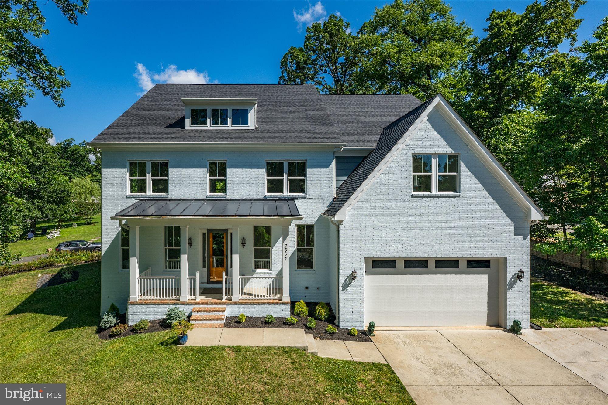 Welcome to 2354 Cedar Lane — a stunning 2022 Stanley Martin built residence in the heart of Vienna offering 4 levels of meticulously appointed living space across four levels, with over $370,000 in builder and post-settlement upgrades. The home sits on a beautifully landscaped, .39 acre lot just minutes from the Orange and Silver Line Metros, Tysons Corner, and Wolf Trap, delivering an exceptional combination of scale, finish quality, and location.
A painted brick facade with standing-seam metal porch roof and covered columned entry set an elegant tone from the street. Inside, 10-foot main-level ceilings and 8-foot solid interior doors establish a sense of grandeur that carries through every room. The open-concept great room is anchored by coffered ceilings, Appalachian Ridge 5" solid oak hardwood floors, a gas fireplace, and a set of French doors opening to the covered rear deck. The chef's kitchen is extraordinary — a 10’ Calacatta Sierra quartz waterfall island with matching backsplash, custom 12-foot-deep cabinetry, a 60" Wolf Dual Fuel Range with infrared griddle and infrared charbroiler, Viking 1,200 CFM hood, built-in Sub-Zero 48” PRO refrigerator, Cove dishwasher, and Wolf 30” PRO microwave. A formal dining room, breakfast room, main-level ensuite, and powder room complete this floor.
Upstairs, the primary suite is a true retreat that consists of an oversized bedroom, a dedicated sitting room with French doors opening to a covered balcony. An extensive walk-in closet and a spa-caliber bath featuring a wetroom shower and dual-vanity with navy cabinetry and brushed gold hardware completes the primary suite. Additionally on the second floor there are two generously sized ensuites, a second-level family room, and a laundry room with Speed Queen Commercial washer and dryer. The third floor delivers a massive bonus recreation room with a full bath, additional bedroom and skylights — ideal for a home theater, playroom, or home office. Below, the unfinished basement boasts 9-foot ceilings and plumbing rough-ins for a full bath, wet bar, and recreation room, offering tremendous expansion potential.
Outdoors, the covered front porch, covered rear deck, and stone paver patio create layered entertaining spaces featuring mature, fruit bearing pear and mulberry trees and pomegranate bushes. The home is further distinguished by 50 windows flooding every level with natural light, pre-wired internet cabling and extended wireless access point for all levels including garage, and a 240V EV charging outlet in the insulated, oversized two-car garage. The butler's pantry and the mudroom sink rough-ins are ready for finishing.The home is well-positioned for commuters while promoting an active, healthy lifestyle within reach. It is less than a minute walk/bike to Tyson’s Wood park that is a direct corridor to the W&OD trail. Roughly a 5-minute walk to Tysons Woods Park. It is a 5-6 Minutes bike ride on W&OD trail to the town of Vienna. Major commuting corridors with radius of less than 2 miles includes I-66/I-66 Express, I-495/I-495 Express, Route 7, Route 123, Route 50, and Route 29. A little over 1 mile to the Dunn Loring Metro Station (Orange Line) and less than 2 miles to the Greensboro/Tysons Metro Station (Silver). Minutes to shopping, dining, and entertainment that includes the Tysons Corner Center, Tysons Galleria, The Boro, Mosaic District, Meadowlark Botanical Gardens, and Wolf Trap National Park for the Performing Arts. 2354 Cedar Lane offers an unmatched combination of new-construction luxury and Northern Virginia's most coveted conveniences. Served by Fairfax County Public Schools.