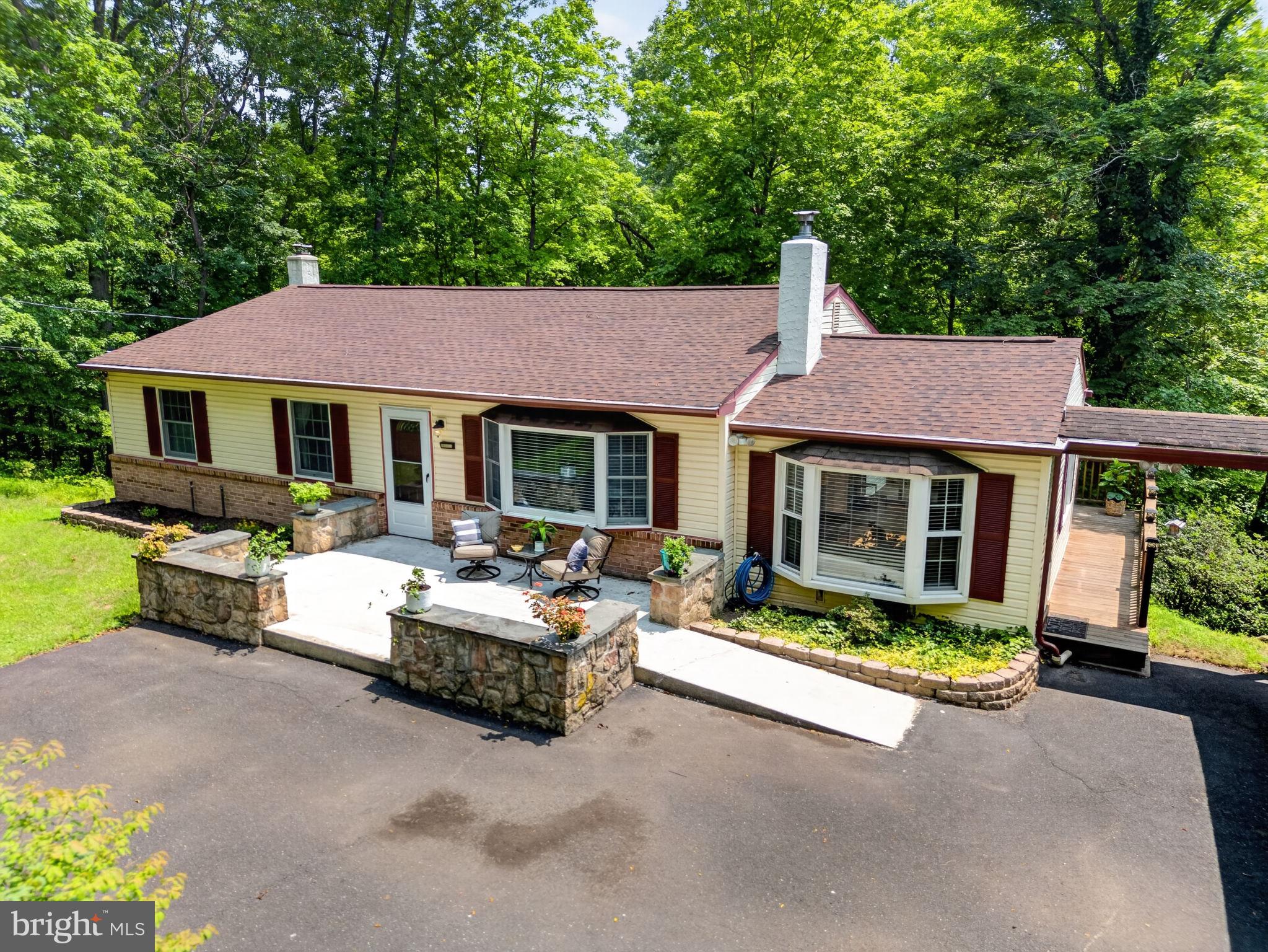 Wake up to ever changing seasonal vistas that rival a mountain retreat everyday!  Located close to major roadways, shopping and entertaining yet tucked away on it's own private sanctuary you'll love the elevated views and undulating terrain surrounded by wildlife and nature at it's finest.  This ranch home has been meticulously maintained as pride in ownership is everywhere you look.  The newer roof with leaf filter gutter protectors, newer water heater, newly renovated car port, a B-Dry basement, and even an entire whole house water filtration system with UV light already installed.  The unfinished basement is ready for your creativity with bright and airy windows and sliding doors that open to the scenic backyard.  Upstairs head into the real retreat where you can really feel a sense of tranquility bringing the outdoors in.  2 decks, one of which opens into a sunroom detailed with wood beams, a skylight, window nook with surround built-ins and also access to the attached car port would make an excellent outdoor entertaining space.  While the second deck offers a private space to relax, Read a book, enjoy the sun, bird watch and take in the wildlife on your own Juliet Balcony off of the Primary Bedroom with a half bath.  2 other bedrooms and a completely renovated hall bath will be found down the hallway and off of the main living areas.  The Kitchen offers the chef of the home plenty of space to get creative for hosted events and for everyday living boasting custom cabinetry detailed with twig replica hardware and.   Stay cool in the warmer summer months with central air conditioning and ceiling fans!  In the cooler months you'll stay warm with the wood burning brick surround fire place with a recently cared for chimney in the welcoming living room.  The hardwood floors and arched entry ways accentuate this superbly cared for home offering a special opportunity for it's new homeowner.  See it live for the first time in over 30 years on Thursday 7/23 at the Twilight Open House from 5-7!  Private showings to start Friday 7/24.