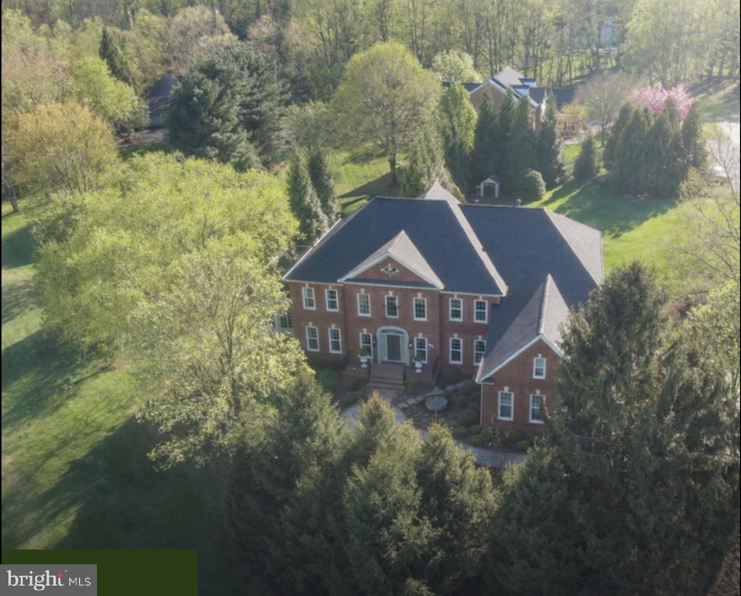 5 BR, 5.5 BA, Exceptional Great Falls living, beautifully scaled for the way buyers want to live today.
This traditional Colonial offers the rare balance of presence, privacy, and ease. Set among mature privacy trees that beautifully frame the property, the home creates the feeling of a private estate without the burden of overwhelming grounds. It is generous enough for gathering, guests, and everyday comfort, yet thoughtfully sized for a lifestyle that feels manageable, elegant, and easy to enjoy. A flagstone and brick walkway leads to the brick porch and front door, setting a gracious tone from the moment you arrive. Inside, natural light moves through beautifully connected spaces, highlighting hardwood floors throughout the main level, including the living room, sunroom, office, and expansive family room with soaring two-story coffered ceilings. The kitchen is refined, inviting, and ready for real use, featuring quartz counters, a generous island, Sub-Zero refrigeration, and a Wolf six-burner range with griddle and double oven. A walk-in pantry, casual culinary lounge, and sunlit morning room create a warm center for daily living, while French doors open to multiple decks for effortless indoor-outdoor flow. A private back staircase and laundry room with utility sink add the kind of function buyers appreciate every day. The dining room is designed for memorable gatherings, with a crystal chandelier, recessed lighting, and generous table space. Formal and informal rooms flow naturally, allowing the home to feel equally suited for quiet mornings, holiday dinners, or weekends filled with friends. Each of the five bedrooms offers its own fully renovated private bath and walk-in closet, giving family and guests comfort, privacy, and ease. Four bedrooms feature hardwood floors, adding to the home’s consistent quality and warmth. The primary suite is a true retreat with a private sitting room, dressing room, and spa-inspired bath featuring heated floors, motorized blinds, lighted mirrors, a soaking tub, and an oversized walk-in shower. The custom closet is exceptional, with built-in cabinetry, jewelry storage, integrated lighting, and tailored wardrobe systems that make daily living feel beautifully organized. The lower level extends the lifestyle with recreation and entertaining spaces designed for fun and relaxation. Enjoy rooms for a pool table, ping pong, indoor golf putting green, fitness, full-size bar, and wine storage room. A hidden panel storage room adds interest, while an additional bedroom and full bath provide flexibility. A large storage room keeps life practical and organized. Walk out to the stone patio and paver fire pit, where mature landscaping, privacy, and open-air gathering spaces create a resort-like feel at home. Multiple decks, peaceful views, and an easy connection to the outdoors make every season more enjoyable. Major improvements include roof in 2024, HVAC in 2026, major renovation in 2023, new asphalt driveway in April 2026, and electric car charger capability. This is a home that has been thoughtfully updated, beautifully maintained, and prepared for its next owner. For buyers seeking Great Falls privacy and comfort, this property stands apart.