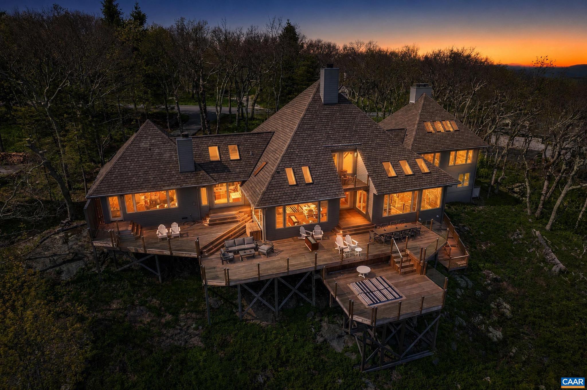 880 Devils Knob Loop is considered by many to be the crown jewel of high-end properties at Wintergreen Mountain. The craftsmanship, architectural composition, and panoramic views are unrivaled. This 6-bedroom, 5 full and 3 half-bath home features custom wood and stonework throughout and is bathed in natural sunlight that pours through floor-to-ceiling windows across every level. The home features multiple fireplaces, with a prodigious stone hearth anchoring the vaulted great room ? a grand yet welcoming space that flows seamlessly into the chef's kitchen. Luxury appointments include Ipe hardwood decking, sleek glass railings, top-tier Viking and kitchenAid appliances, and a built-in outdoor hot tub. 880 Devils Knob offers a singular experience ? as though you are floating effortlessly above the mountains. This refined, elegant, and truly one-of-a-kind retreat stands in a class of its own.,Granite Counter,Painted Cabinets