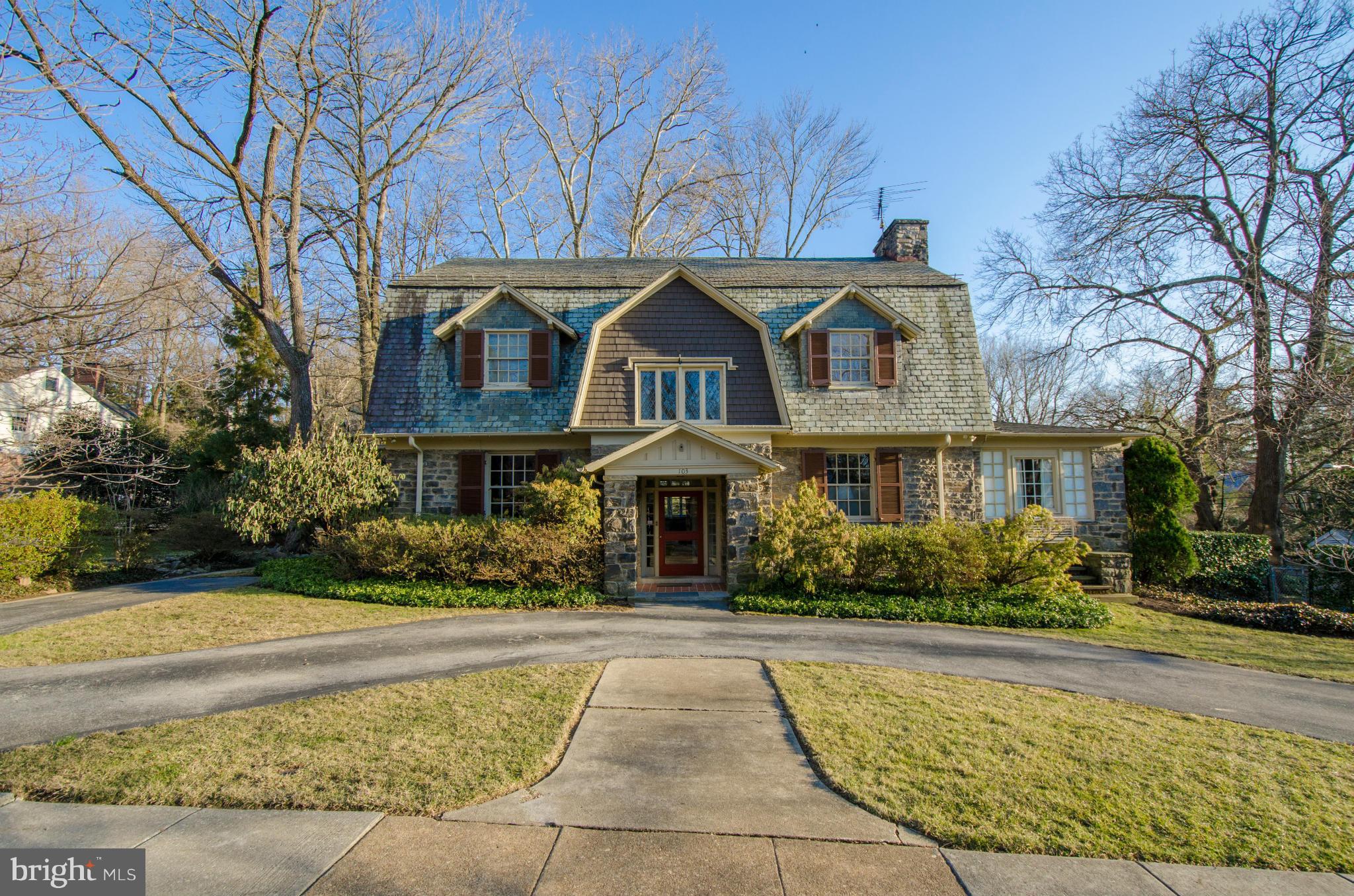 Handsome sun-filled stone residence w/glorious gardens, spacious level lawn & terrace w/awning. Grand foyer, architectural detailing, 9 ft ceilings  & generous room sizes. Updated master suite w/over-sized bath & 14x10 walk-in closet. Space for 6 cars in semi-circular driveway. Full basement w/tons of storage space. Well-priced to reflect need for some updating.