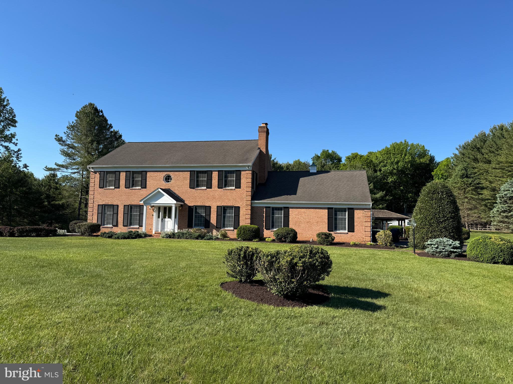 Situated in the heart of Western Howard County, this exceptional custom home offers a rare combination of superb location,  quality of craftsmanship (this was the builder's personal home) and a spectacular lot all on 3.82 landscaped acres.  Rarely do homes come available in this neighborhood.  This timeless, solid brick, colonial style home includes 4 bedrooms, 3.5 bathrooms with a 2-car attached garage and 2-car detached garage.  You’ll truly appreciate the stunning sunroom on the main level.  You will have the convenience of a mudroom/ laundry off of the garage on the main level.  The level of detail and craftsmanship throughout the home truly stands out.  The entire home has been freshly painted and new carpeting has been installed in the bedrooms.  The floors have been recently sanded and refinished.  The basement is finished with 2 distinct rooms as well as a utility room.  The outside of the home includes a brick patio with a pergola, an inviting fenced pool area with a kidney shaped concrete pool and a cabana too.  The 2-car detached garage compliments the home and could possibly be converted to an  Accessory Dwelling Use (ADU) or in-law suite or pick a totally separate location on this expansive lot.  While the home was built to the builder's exceptional standards and maintained meticulously, it is priced to allow the buyer to use their own vision for updates to the Kitchen and Bath areas.  The location is in the  sought-after Howard County School System and is commuter friendly to Washington, DC and Baltimore.  This is truly a gem to own a home that combines a lovely outdoor space with architectural excellence in such a special setting.