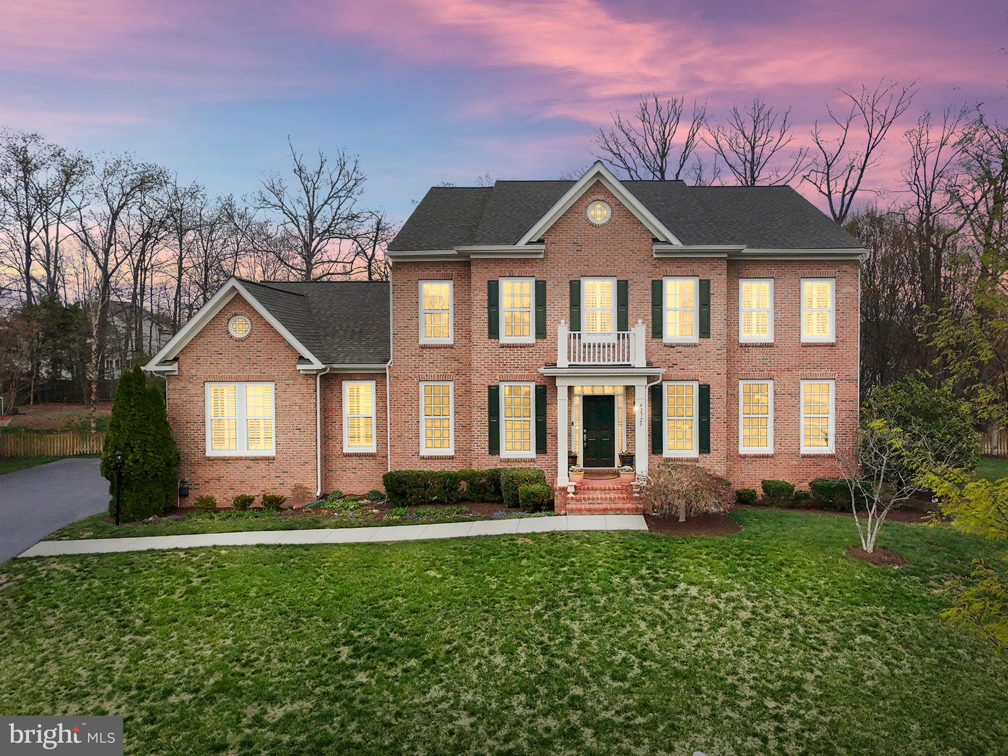 Welcome to this exquisite brick-front Colonial, perfectly situated at the end of a quiet cul-de-sac. Boasting 4 bedrooms, 5.5 bathrooms, and over 5,600 square feet of living space, this home offers a 3-car garage and a stunning open-concept kitchen featuring granite countertops, stainless steel appliances, a stylish backsplash, and a spacious island. The light-filled family room is perfect for gatherings, complete with a cozy stone fireplace. The main level showcases elegant hardwood floors, shadowboxing, and crown molding details. A large mudroom off the garage provides a convenient sink and ample storage. Upstairs, the primary suite impresses with a tray ceiling, a walk-in closet, and a luxurious ensuite bathroom featuring dual sinks, a soaking tub, and a separate shower. Three additional spacious bedrooms each have their own ensuite bathroom, and the upstairs laundry room is equipped with cabinetry and a sink for added convenience. Plantation shutters adorn every window, adding timeless elegance. The finished lower level features a bar area, a full bathroom, and extra storage, with the option to easily add a legal 5th bedroom. Step outside to the expansive backyard with a patio, ideal for relaxing and entertaining. As part of the Brambleton HOA, residents enjoy Fios cable and internet, pools, scenic trails, tennis courts, and playgrounds. This home is just minutes from Brambleton Town Center, offering a variety of dining, shopping, and a vibrant farmers market. With close proximity to Dulles Airport and the Ashburn Metro Station, commuting and travel are effortless. This home offers the perfect blend of luxury, comfort, and functionality. Don’t miss this incredible opportunity—schedule your showing today!