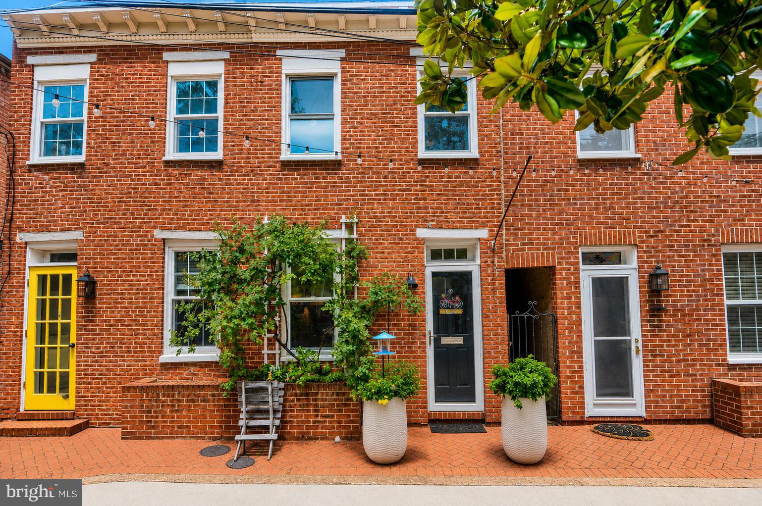 Tucked away on a quiet cobblestone lane, 1247 Knox Court feels like a hidden treasure in the heart of the city. From the moment you arrive, you'll be captivated by its storybook setting and undeniable charm. This is the kind of home that makes you slow down, linger a little longer, and imagine yourself settling into a simpler pace of life.

Inside, natural light pours through the home, highlighting the warm and inviting living spaces. The open main level flows effortlessly from the living room to the kitchen and dining area, creating a space that feels both cozy and connected. A wood-burning fireplace anchors the living room, creating a warm and welcoming heart of the home where conversations linger and everyday moments feel a little more special.

Just beyond the dining area, a rear deck overlooks a charming courtyard, offering a wonderful spot for morning coffee, container gardens, or intimate outdoor dinners under the stars.

Upstairs, two comfortable bedrooms share a beautifully renovated full bath. A skylight fills the hallway with sunshine, while sliding doors lead to a private second-floor balcony—a delightful retreat for enjoying a quiet morning or unwinding at the end of the day.

The lower level provides valuable storage space along with a convenient laundry area. Lovingly maintained and thoughtfully updated, the home offers peace of mind with a new roof featuring a silicone finish installed in 2022, a new HVAC system installed in 2022, and a new washer and dryer added in 2023. The kitchen received a tasteful refresh in 2023 with a new sink and countertop, while both the upper and lower decks were freshly stained that same year. Truly move-in ready, this home combines character, comfort, and practicality in equal measure.

Best of all, you'll enjoy one of Baltimore's most desirable locations, with easy access to the shops, restaurants, parks, and waterfront destinations of both Federal Hill and Locust Point. With the Inner Harbor nearby and I-95 just minutes away, city living has never felt so charming. 1247 Knox Court is proof that sometimes the most special homes come in the most delightful packages.