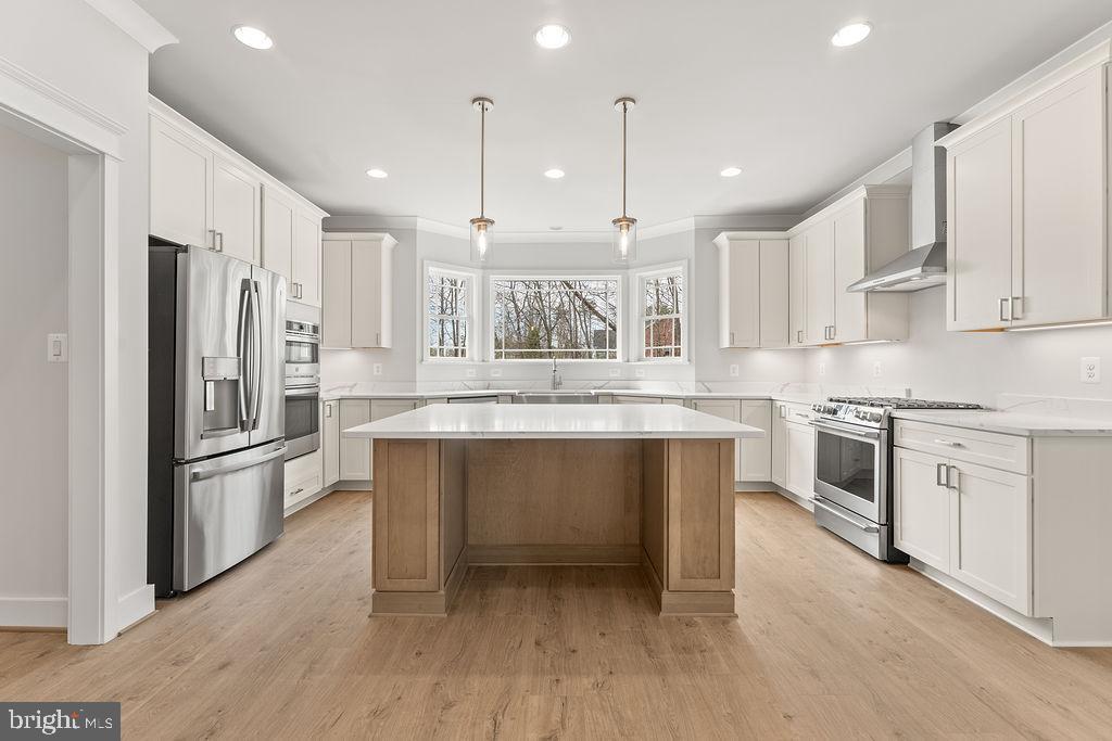 Experience luxury living at its finest in this stunning MOVE-IN READY custom new construction home, perfectly situated on 2 private acres. Thoughtfully designed with exceptional craftsmanship and upscale finishes throughout, this home offers an elegant yet functional layout ideal for everyday living and entertaining.

The heart of the home is the spectacular gourmet kitchen, featuring premium stainless steel appliances, including an upgraded range and a double wall oven/microwave combination, custom cabinetry, beautiful countertops, an oversized center island, and a spacious walk-in pantry that provides exceptional storage.

The dramatic two-story family room is filled with natural light from expansive windows and is anchored by a beautiful gas fireplace, creating a warm and inviting gathering space. Adjacent to the family room, the sunroom offers the perfect place to relax while enjoying peaceful views of the surrounding property.

The main level also features elegant formal living and dining rooms, a private study ideal for working from home, and a convenient laundry room. Upstairs, a second laundry room adds even greater convenience for everyday living.

Retreat to the luxurious primary suite, complete with a spa-inspired bath featuring an oversized shower, dual vanities, generous walk-in closets, and a tranquil atmosphere designed for relaxation. Each additional bedroom includes its own private en-suite bathroom, providing comfort and privacy for family members and guests alike.

Set on a beautiful 2-acre homesite, this exceptional residence offers the perfect balance of privacy and convenience, with easy access to I-95, shopping, dining, parks, and everything Fredericksburg has to offer.

This extraordinary home combines timeless design, premium finishes, and an exceptional floor plan to create a truly one-of-a-kind living experience. Schedule your private tour today and discover everything this remarkable home has to offer.