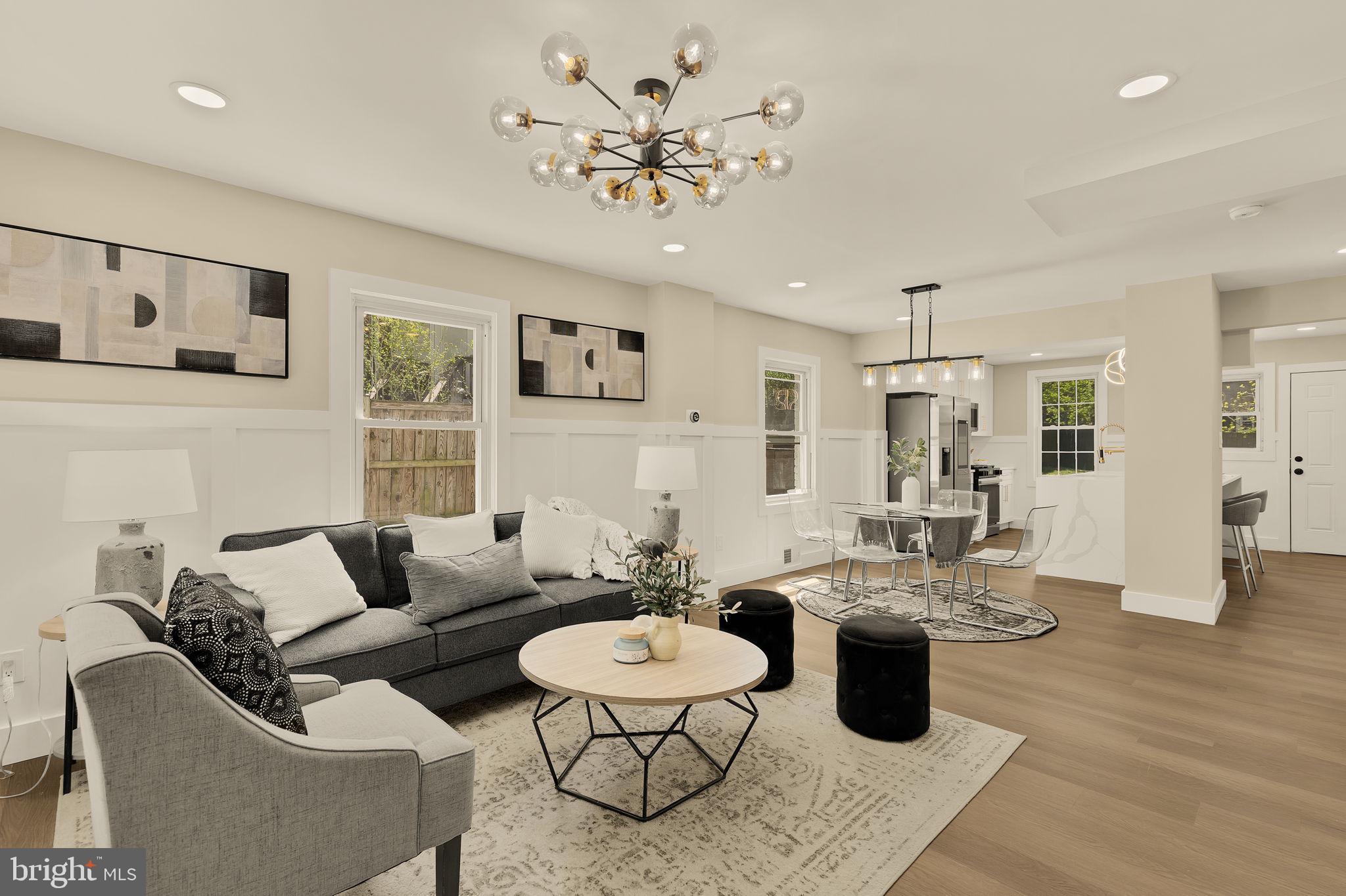 OPEN HOUSE - Saturday 4/18 from 12-3pm. Just three blocks to the Huntington Metro, this completely renovated home offers three levels of thoughtfully designed living space with a modern, open-concept layout. From the moment you step inside, you’ll notice the fresh paint, new flooring throughout, custom trim work, and premium lighting and fixtures that elevate every space. The heart of the home is the stunning kitchen, featuring quartz countertops, high-end cabinetry, premium tile, stainless steel appliances, gas cooking, and a large center island perfect for gathering. The kitchen offers space for casual dining, along with a separate dining area that gives you flexibility for both everyday meals and hosting.  A convenient main-level powder room adds functionality and ease.  The upper level features two bedrooms and a shared hall bathroom, elegantly designed with high-end selections and tile. The lower level offers a third bedroom with closet space and a second full bathroom, providing flexibility for guests, a home office, or additional living space.  Enjoy mornings on the covered front porch and evenings in the fully fenced backyard, offering a great space for relaxing or entertaining. The property also includes off-street driveway parking for two cars with the potential to extend for a third if desired.  With lovely curb appeal and a prime location just minutes to Metro access, this home combines style, comfort, and convenience in one exceptional package.