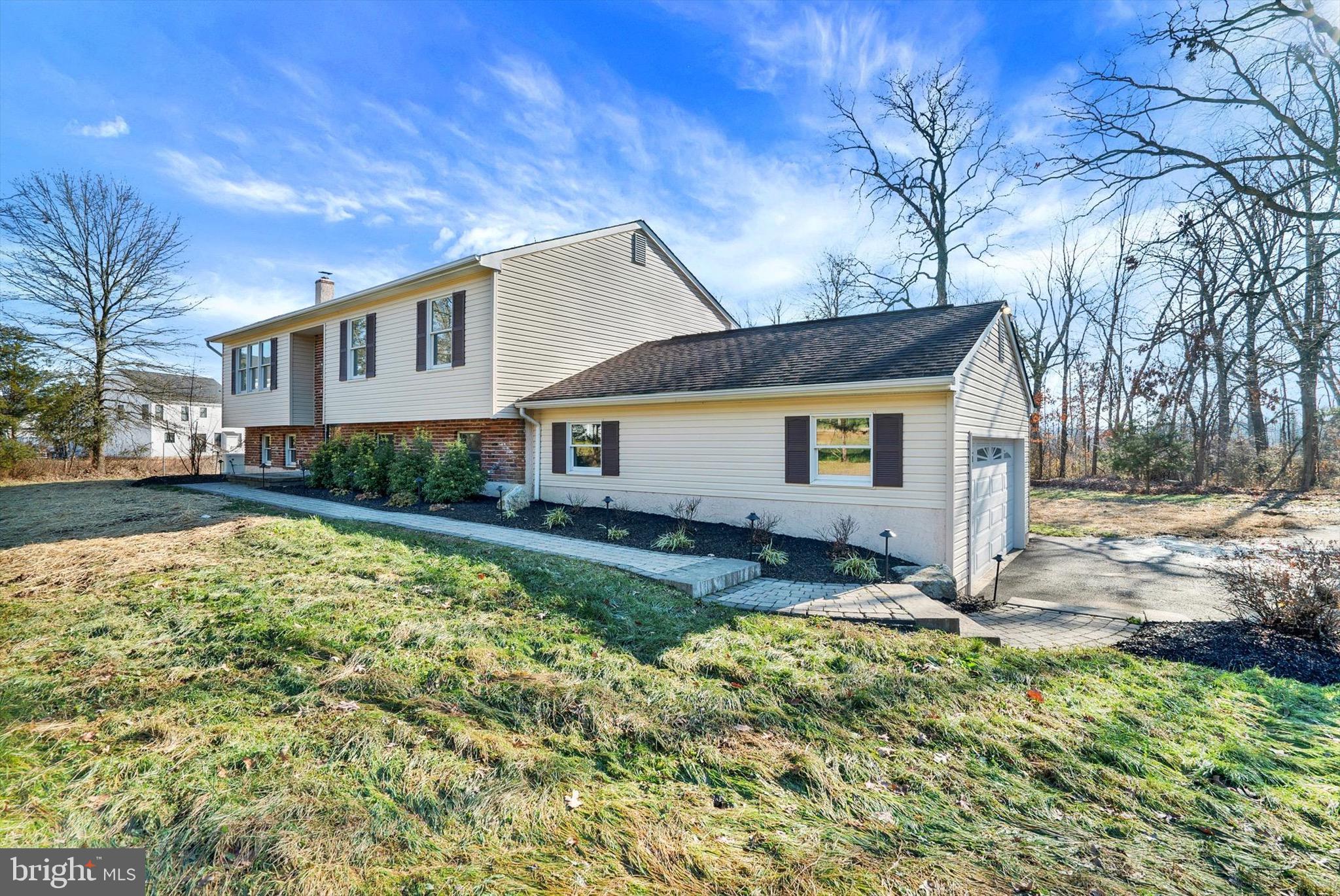 This traditional style Colonial home embodies the serenity of  Bucks County yet offers a unique sense of community and belonging with the neighboring homes.  The home sits upon 2.181 acres of land in Plumstead Township and Central Bucks School District. This home hosts seven rooms. The kitchen has been recently renovated.  White crisp kitchen cabinets, tile backsplash, granite counter-tops, white Blanco farm-house sink, wood floors, pantry, freshly painted and new lighting.  The breakfast room is adjacent to the kitchen with new lighting and glass sliding doors that lead out to the deck.  The inviting living room is large in scale with a wall of windows, new flooring and fresh paint.  Down the hall you are greeted with two generous sized bedrooms both with ample closet space, new flooring and fresh new paint.  Both secondary bedrooms share a full hall bath.  The main bedroom offers new flooring, generous sized closet, fresh new paint, new ceiling fan and a full bath.  The family room is located on the lower level of the home.  It showcases exposed beams, a handsome wood burning fireplace, rustic wood trim, new carpet and fresh new paint.  Off of the family room is a large bonus room with custom built ins, half bath, laundry room, bar area and private entrance.   The grounds are beautiful with paver walkways, exterior lighting, planting beds, large paver patio and a park like setting of beautiful land and views.  A shed for additional storage, a generator, gas line for your grill, and a  two car garage that completes this home.